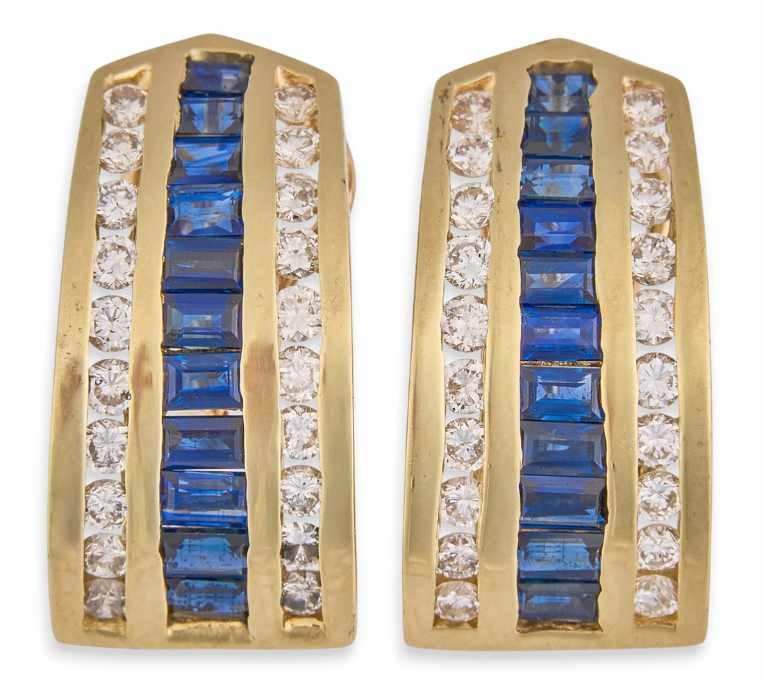 14K Sapphire and Diamond Earrings: Pair of 14K yellow gold (tested) huggie style earrings set with a central row of baguette cut sapphires, flanked by rows of round brilliant cut diamonds, approximately 1.60 ctw, graded I–J 