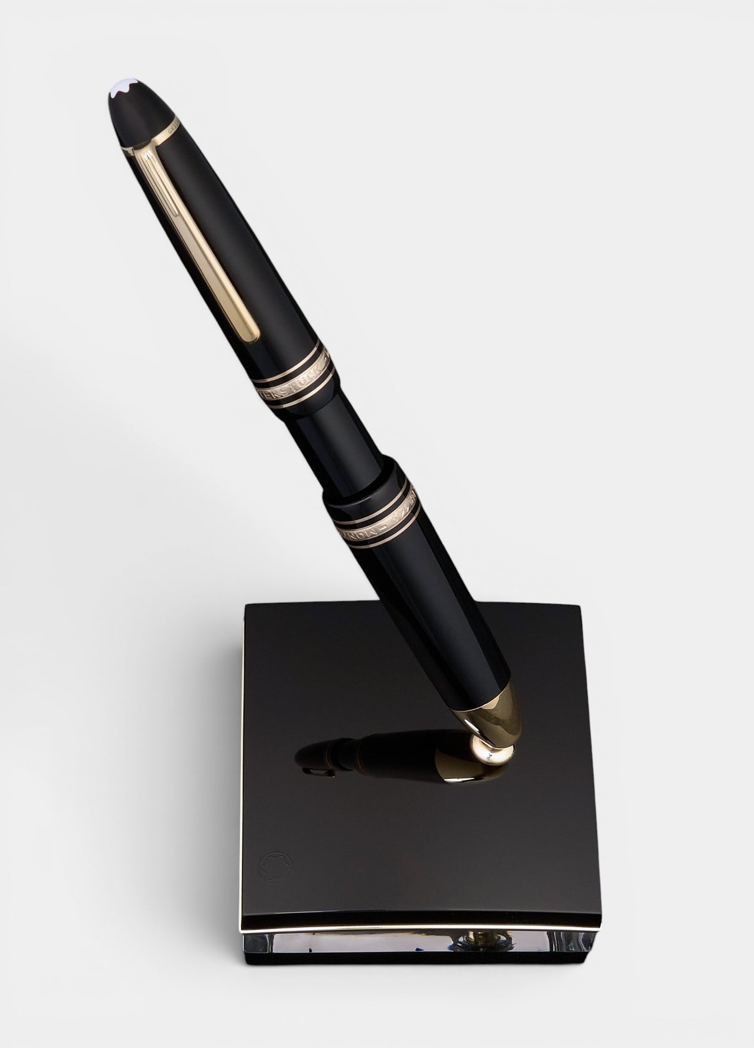 Montblanc Meisterstuck Ballpoint Pen & Stand: Montblanc "Meisterstuck" series ballpoint pent, marked with serial number "GK1158322", with stand height 4 in. x width 3 in. x depth 3 in. / stand Provenance: Property from th