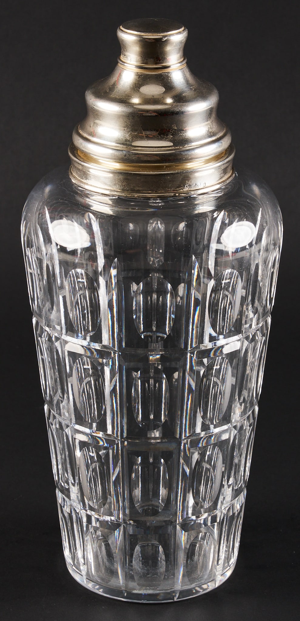 Baccarat Equinox Cocktail Shaker: Baccarat crystal cocktail shake in Equinox pattern with sterling silver strainer lid, and rim, both marked "Sterling 3" height 11.25 in. x diameter 5 in. Total weight: 44.245 ozt weigh