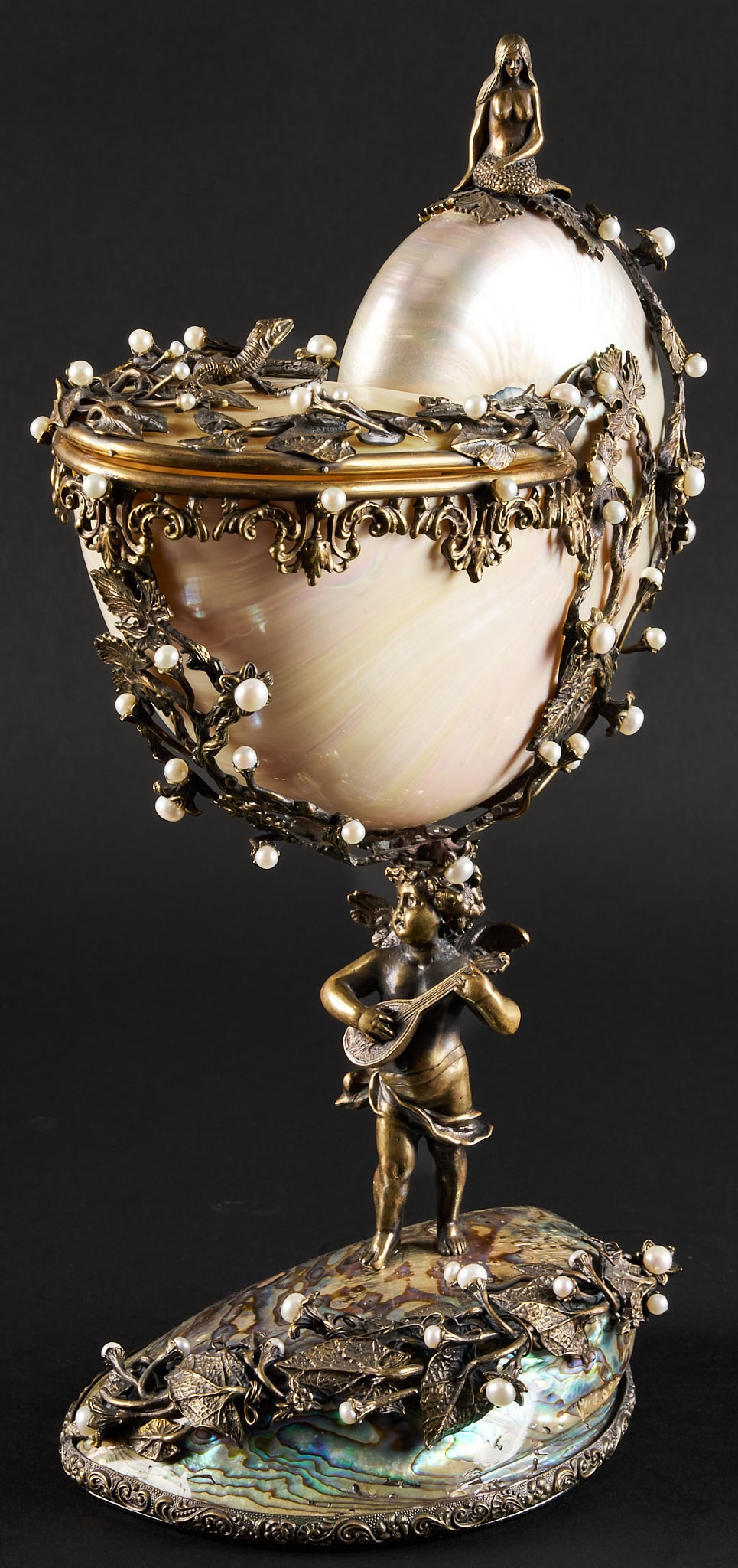 Nautilus: Nautilus featuring intricate bronze mountings with pearl decoration, and figural motifs, supported on abalone shell base height 14.25 in. x width 6 in. x depth 9.25 in. 