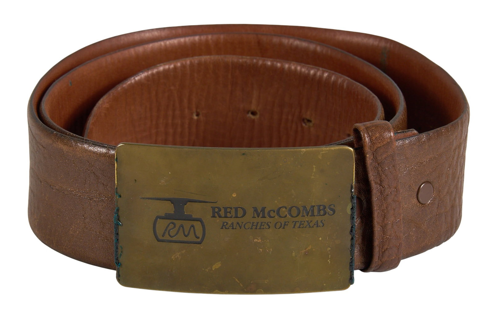 Red McCombs | Red McCombs Ranches of Texas Steerhide Belt, Size 42: Red McCombs hand-crafted steerhide belt with brass Red McCombs Ranches of Texas belt buckle, size 42 Condition B; good condition, overall structure maintained with evidence of everyday use