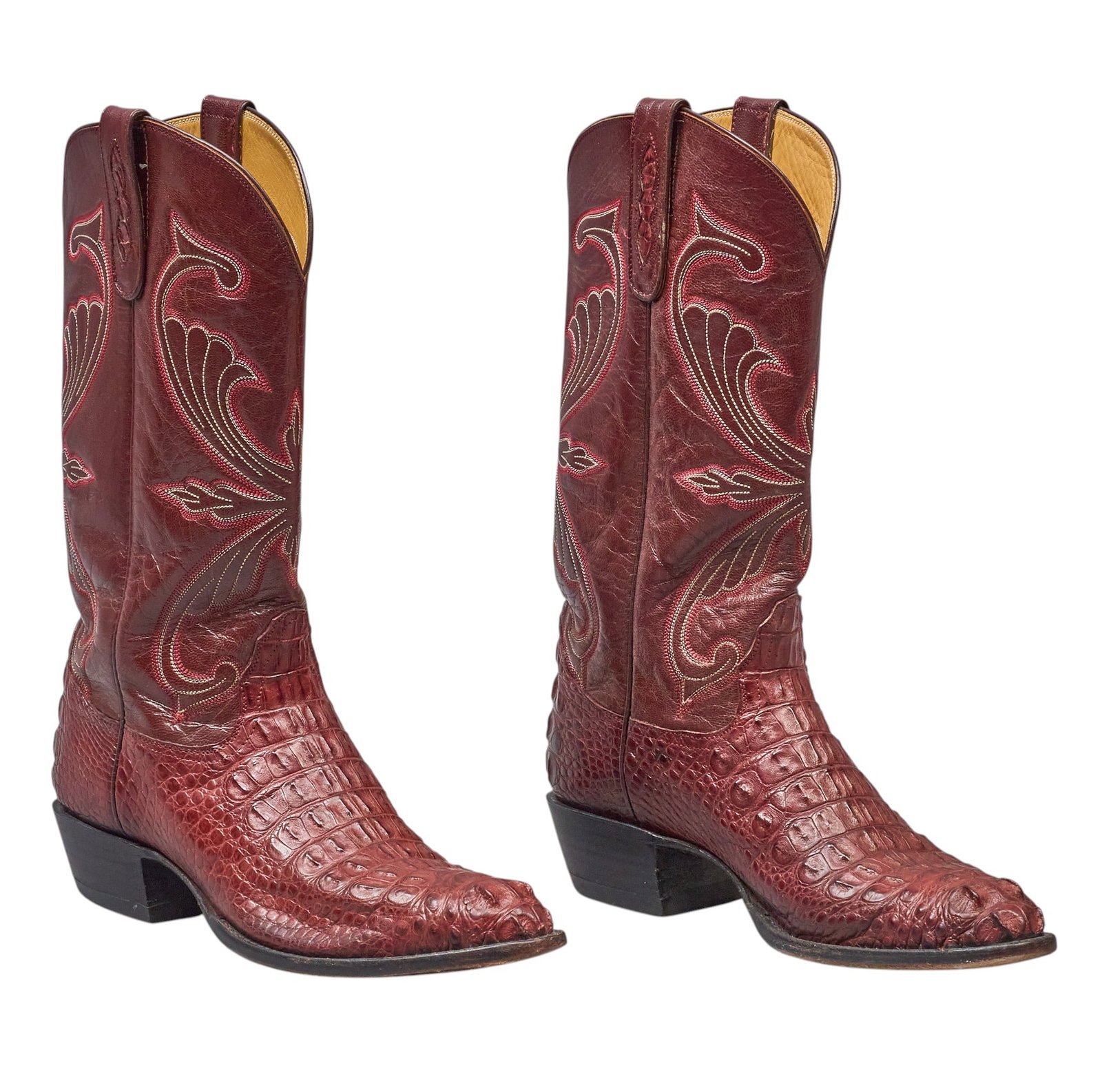 Red McCombs | Pair of Caiman Tail Cowboy Boots: Pair of burgundy leather cowboy boots with decorative stitching, and caiman tail leather vamps, size 12 B height 14.5 in. x width 4.5 in. x depth 12.5 in. / each Condition AB; very good condition, reg