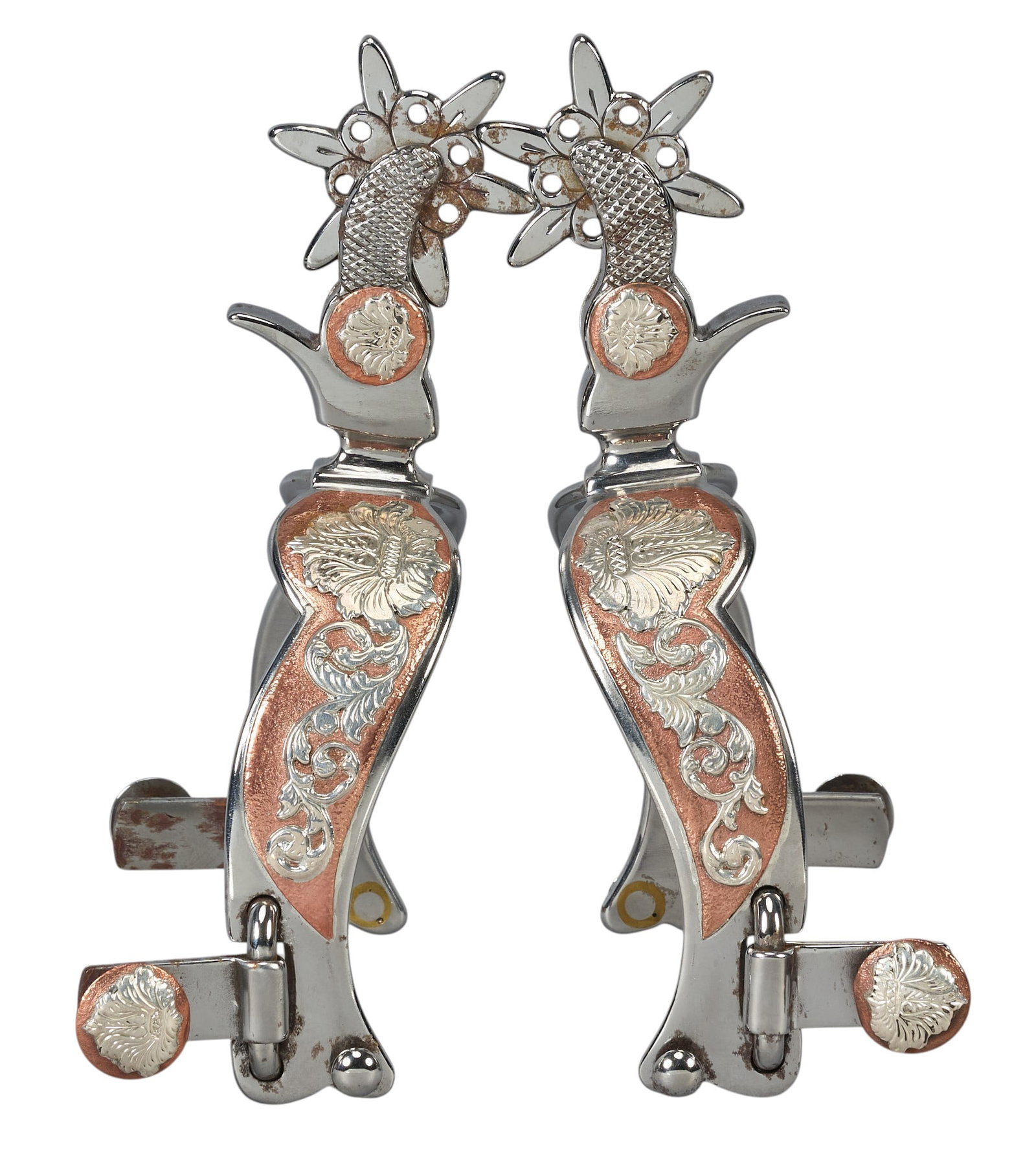 Red McCombs | Pair of Russel Yates Silver Metal Spurs: Pair of Russel Yates (Rotan, Texas) silver metal spurs with copper inlay and plant motifs, marked "RYates, 164" overall length: 6.5 in. heel width: 3.5 in. rowel diameter: 1