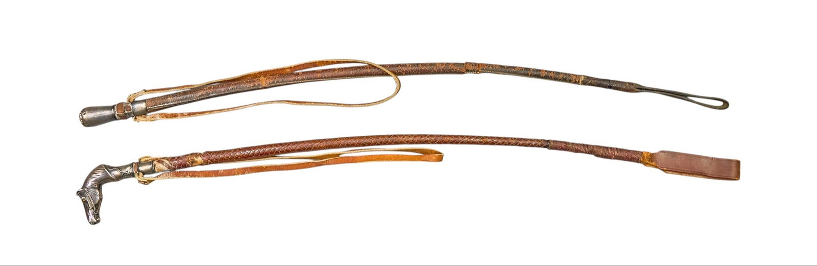 Red McCombs | (2) Riding Crops: Two vintage leather riding crops with silver-plated handles, one featuring horsehead motif length 31 in. x width 2 in. / largest Provenance: Property from the personal estate collection of iconi