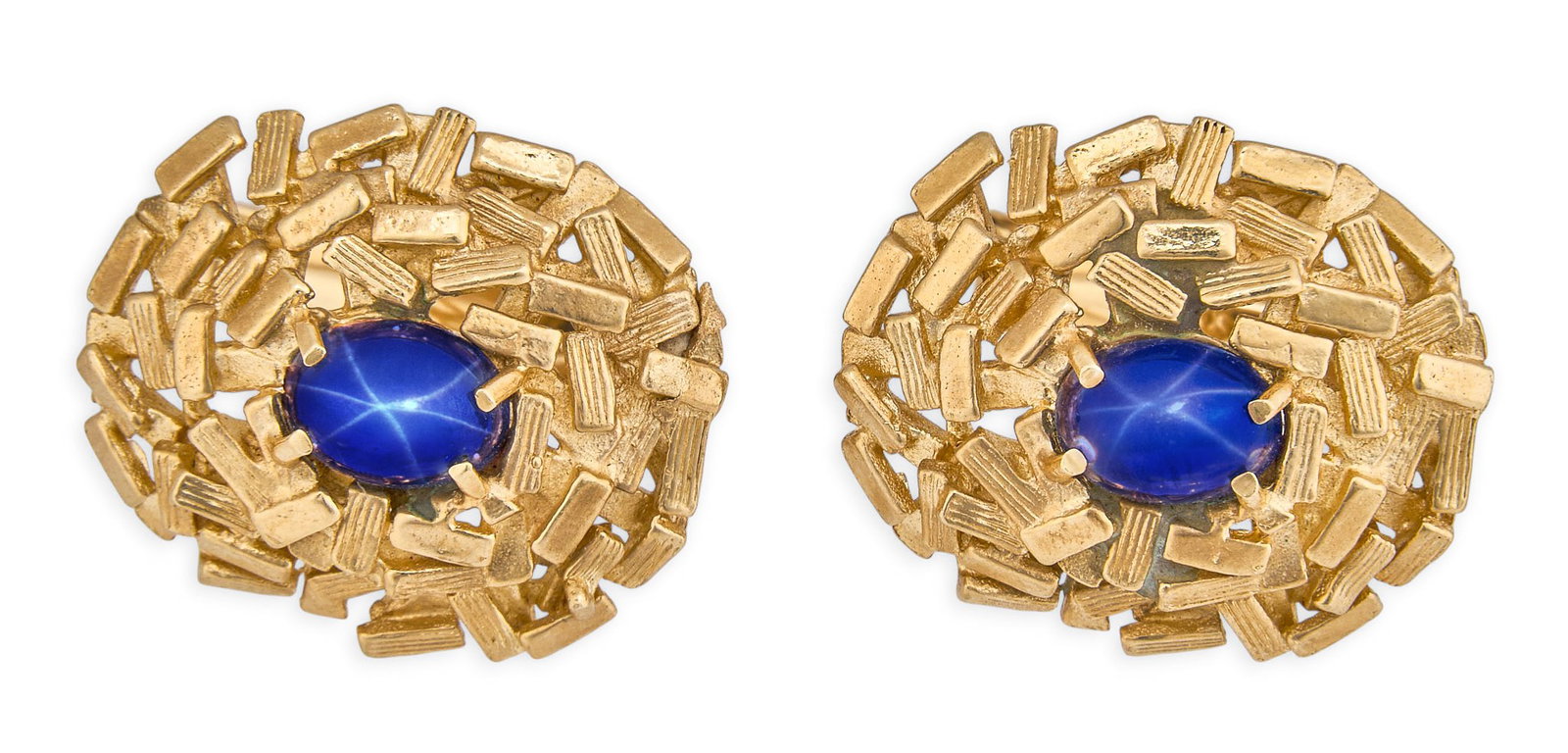 Red McCombs | 14K Star Sapphire Cufflinks: Pair of 14K gold cufflinks set with star sapphire oval cabochons in sculpted plates, marked "14K" Size: 3/4 in. x 7/8 in. / each Total weight: 14.4 g Provenance: Property from the