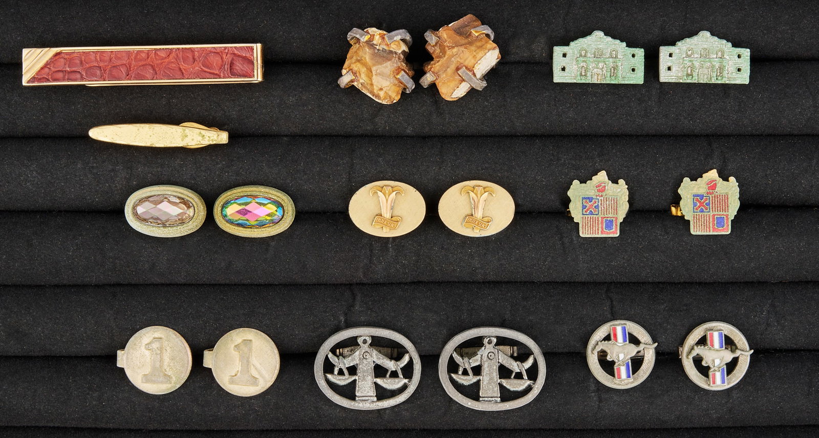 Red McCombs | Collection of Cufflinks & Tie Clips: Collection of cufflinks and tie clips featuring various designs including scales of justice, architectural motifs, and abstract patterns Provenance: Property from the personal estate collection of