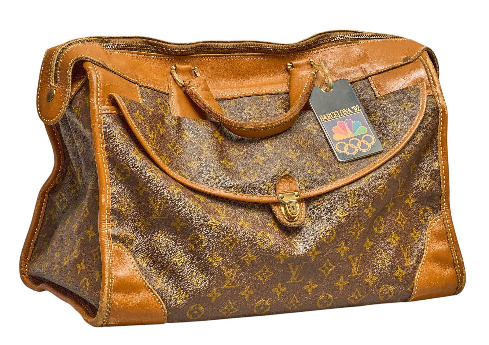 Red McCombs | Vintage Louis Vuitton French Company Weekender Bag: Vintage Louis Vuitton French Company weekender bag, with brown monogram canvas, includes Barcelona 92 Olympics tag with Charline and Red McCombs address height13 in. x width 17 in. x depth 11