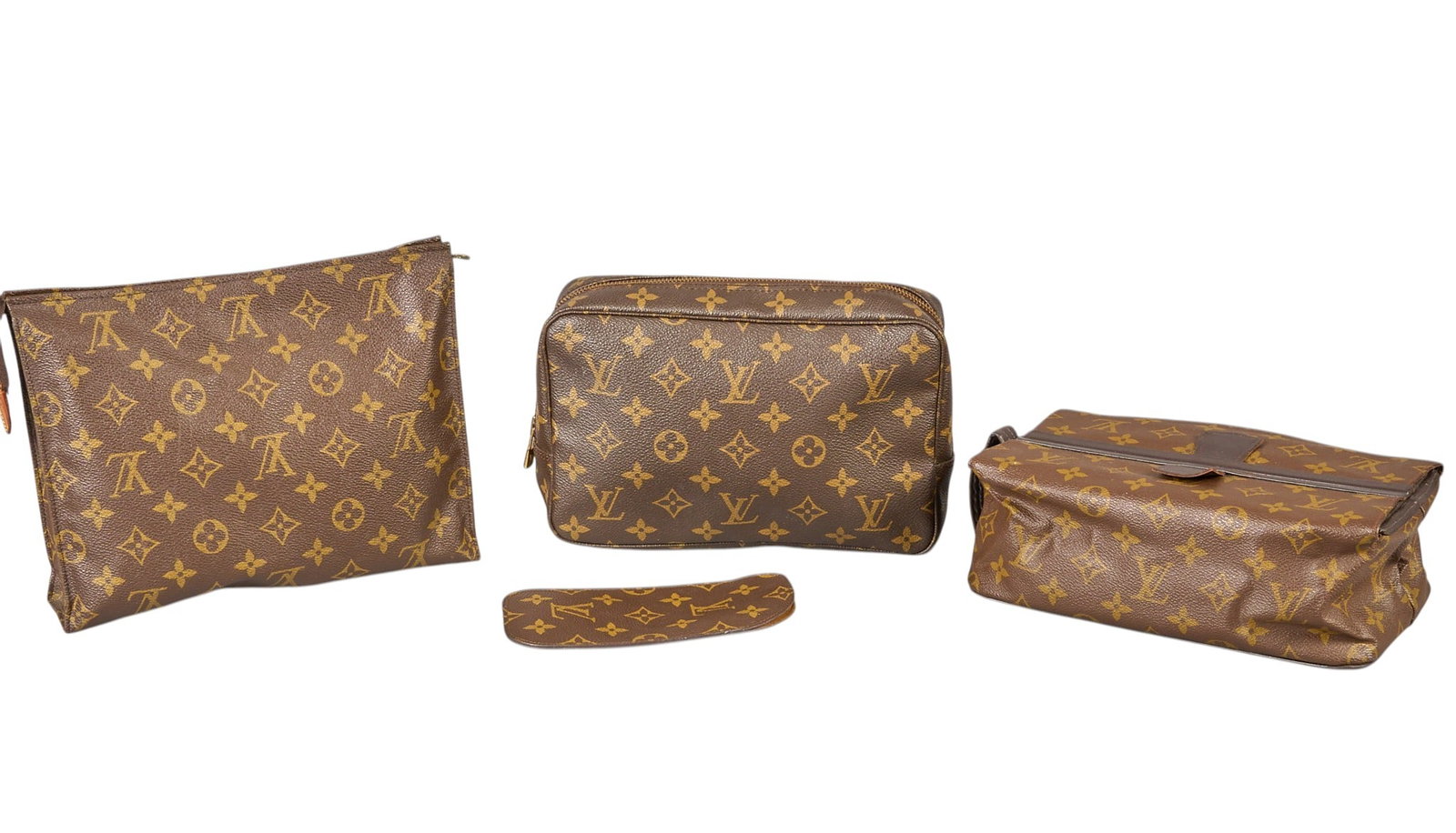 Red McCombs | (4) Vintage Louis Vuitton Travel Bags and Travel Loop: Four vintage Louis Vuitton accessory and travel bags, with brown monogram canvas, includes handle loop 10 in. x 7.5 in. x 3 in. / largest Condition AB; very good condition, regular wear signs