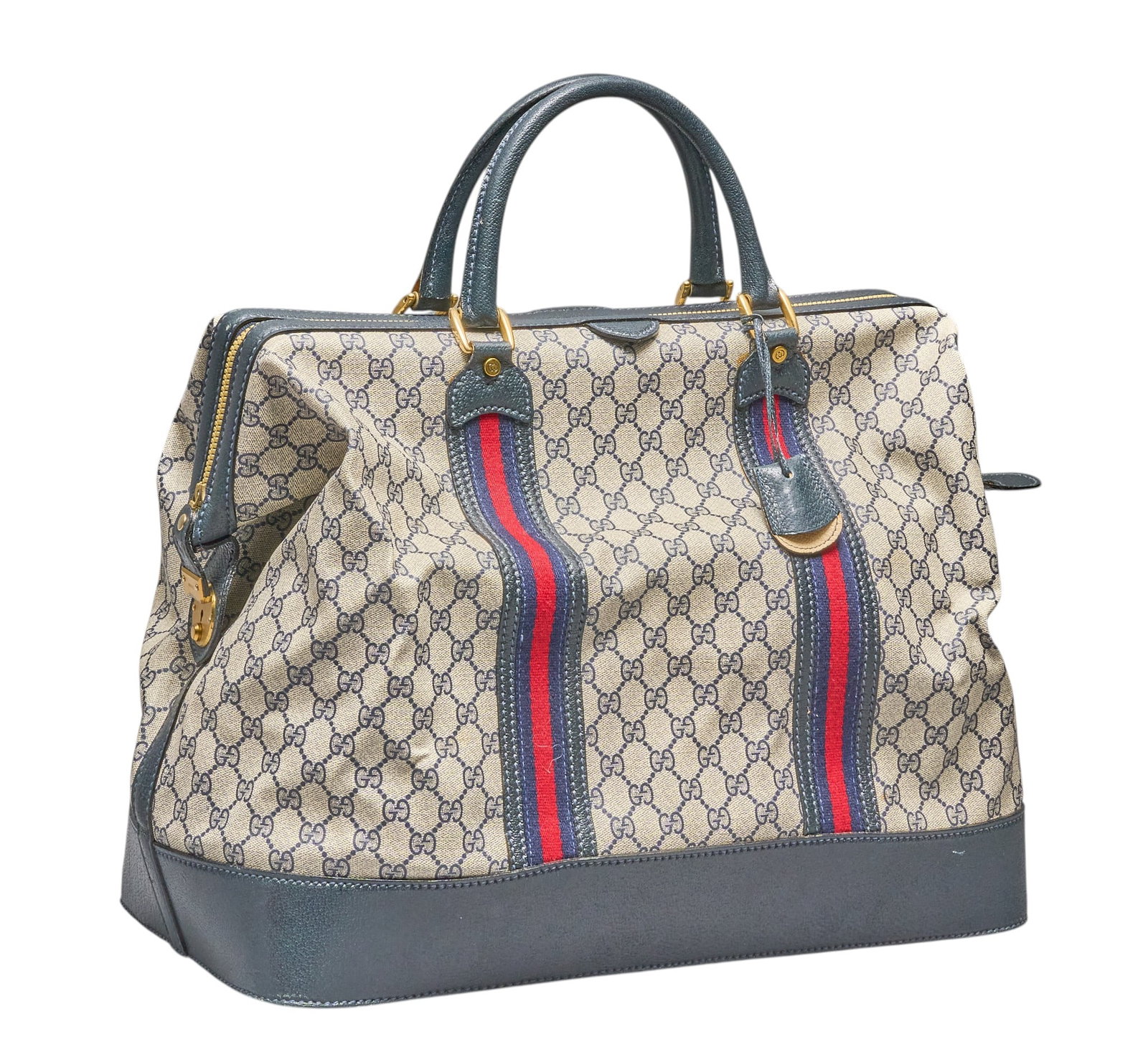Red McCombs | Gucci GG Supreme Travel Bag: Gucci GG Supreme travel bag of monogram canvas, with blue leather handles and trim, and golden hardware height 19 in. x width 18.5 in. x depth 9 in. Condition A; excellent condition, 