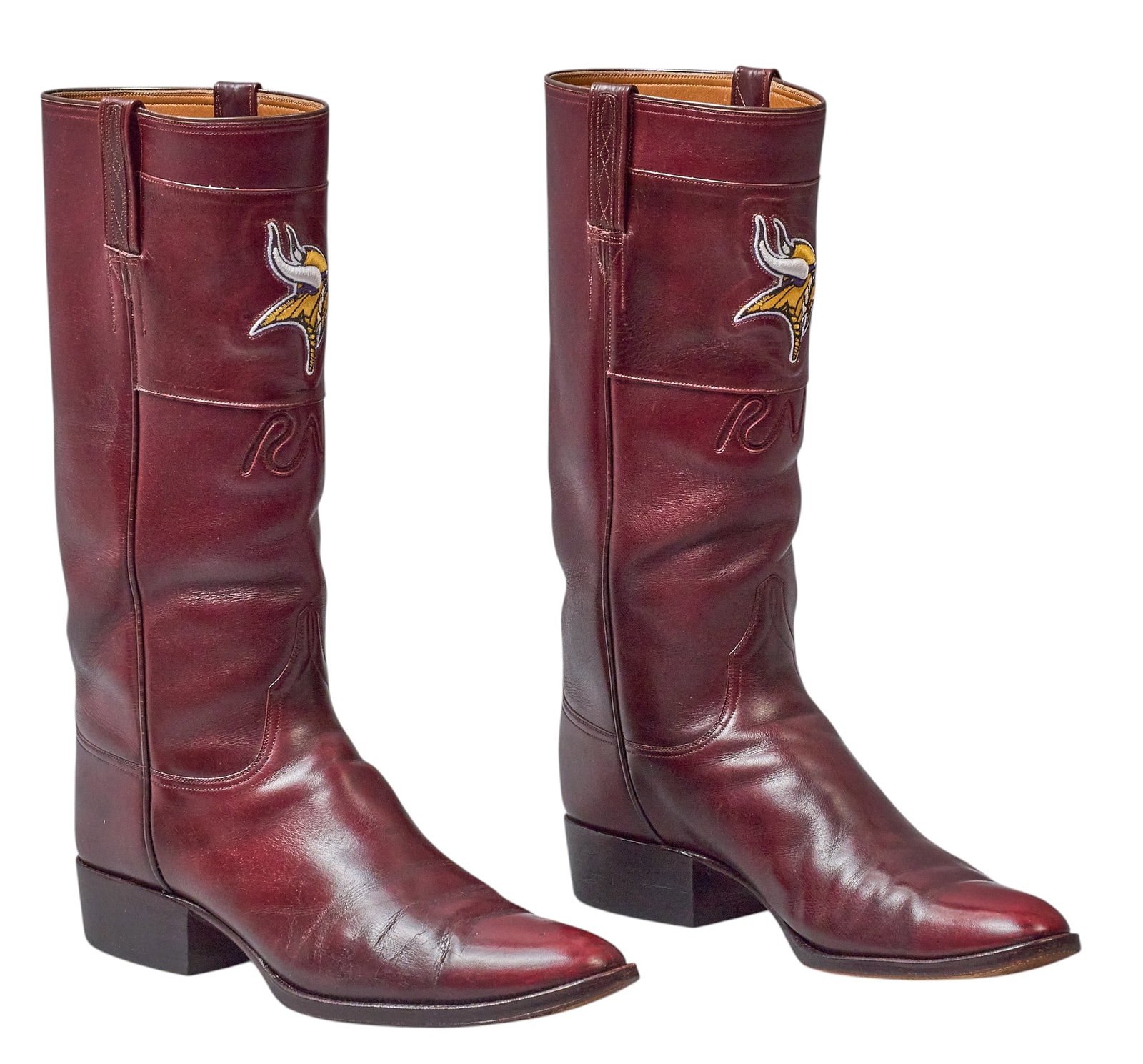 Red McCombs | Pair of McCombs Ranches x Minnesota Vikings Leather Boots: Pair of customized maroon leather riding boots produced by Littles Boot Company (San Antonio, Texas) featuring McCombs Ranches brand, and Minnesota Vikings football team emblem; size not marked, 