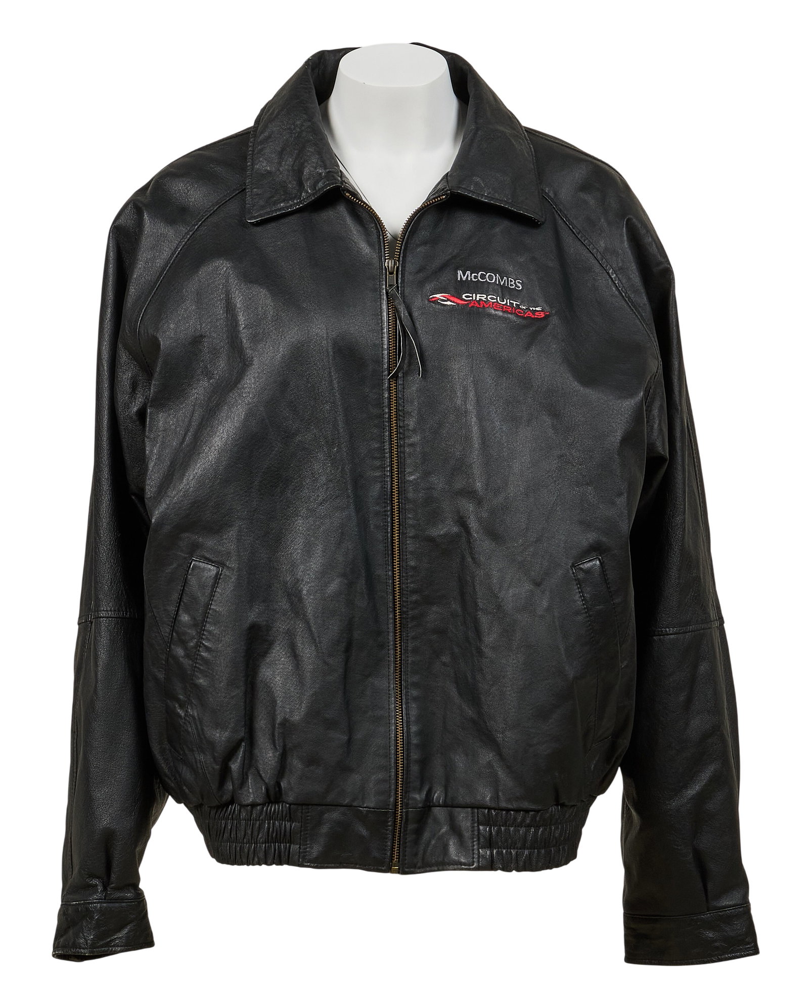 Red McCombs | Customized Circuit of the Americas Leather Jacket: Burk's Bay customized black leather jacket, embroidered "McCombs" and "Circuit of the Americas" logo, with zipper closure, slit pockets, and one interior pocket overall l