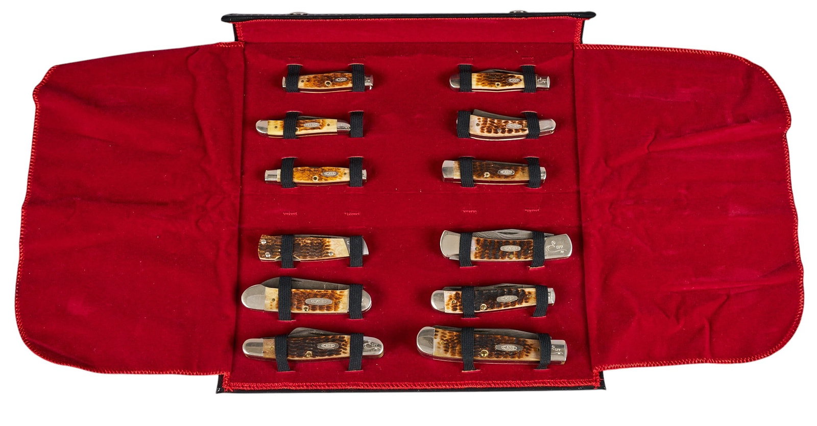 Red McCombs | Case Centennial 1889-1989 Commemorative Knife Set: Collection of twelve Case XX Centennial knives, celebrating 100 years from 1889 to 1989, featuring bone handles and stainless steel blades, presented in a red-lined black faux leather display cas