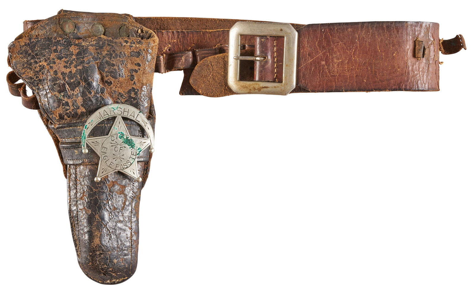 Red McCombs | Leather Belt & Holster W/ Silver City of El Paso Marshal Badge: Leather belt & holster W/ Silver City of El Paso Marshal badge leather is very worn; bullet loops are ripping; badge has light patina with verdigris Provenance: Property from the personal est