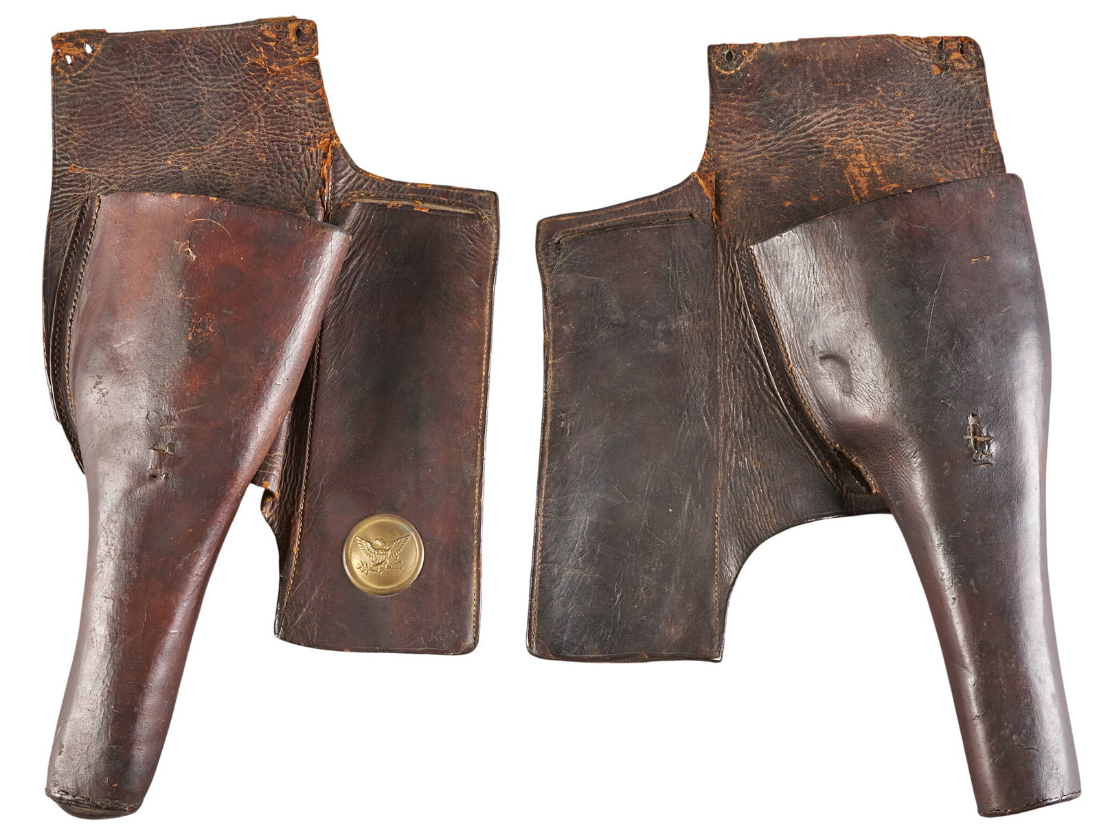 Red McCombs | Pair of Mid 19th Century US Leather Saddle Holsters: Pair of Mid 19th Century US Leather Saddle Holsters with brass American eagle seal condition commensurate with age; tears throughout Provenance: Property from the personal estate collection of iconic 