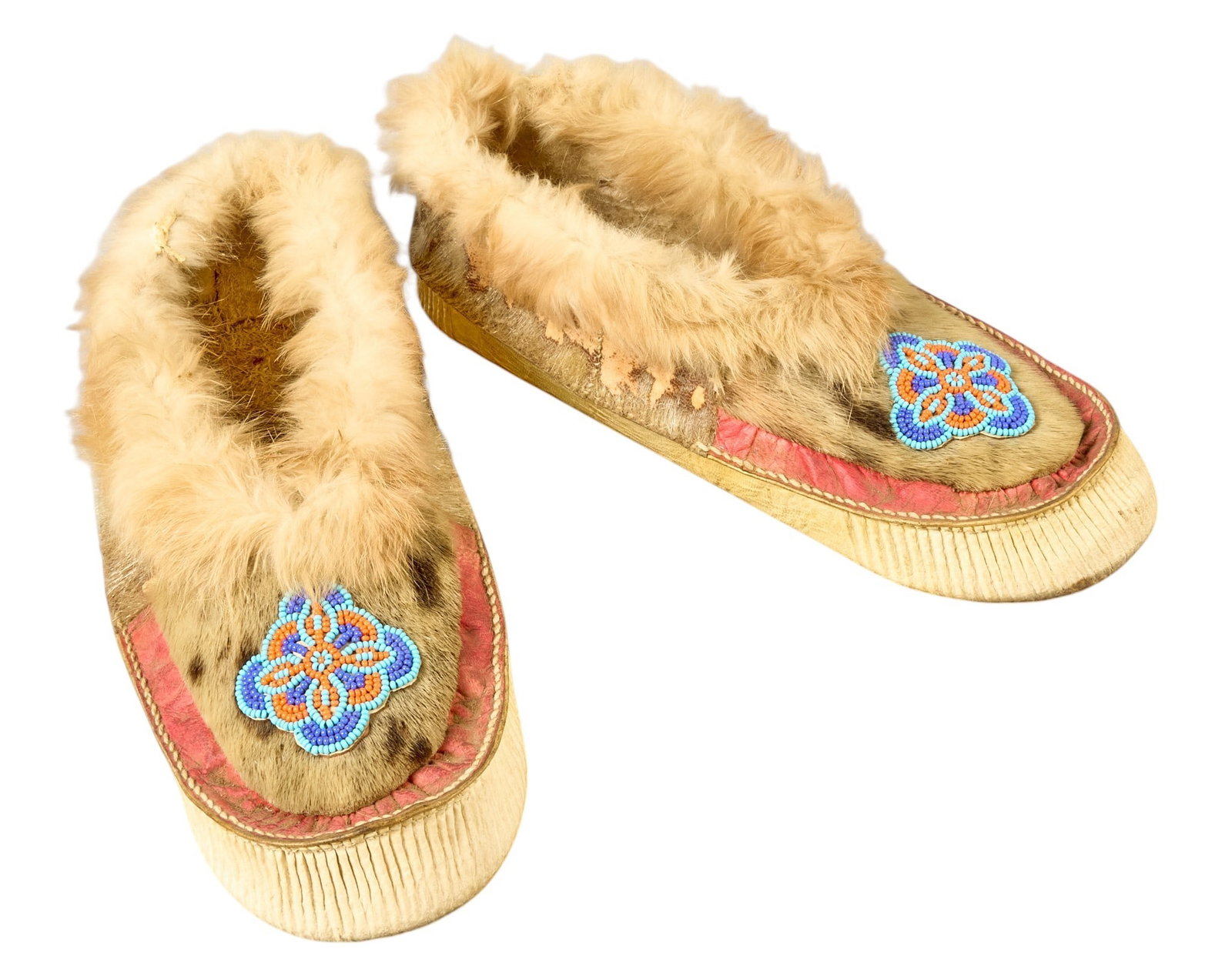 Red McCombs | Pair of Beaded Moccasins: Pair of beaded moccasins decorated with animal pelt and hair on hide height 3 in. x width 5 in. x depth 11 in. Prove