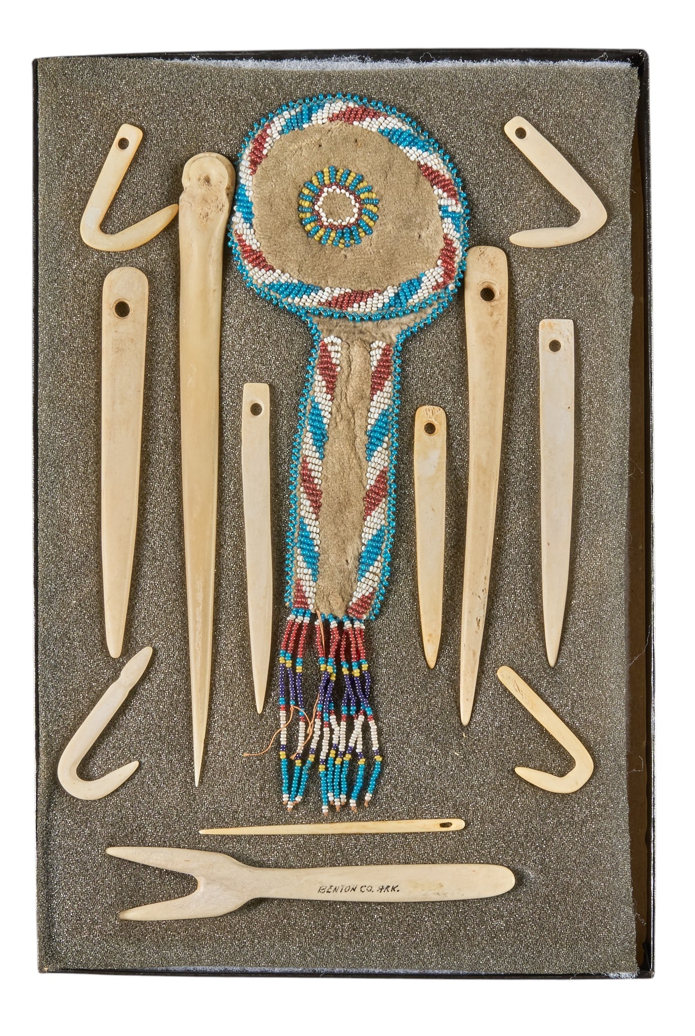 Red McCombs | Framed Native American Tools and Beaded Bag: Framed display of Native American hand-beaded awl case, with collection of carved bone tools, mostly needles, circa 19th century height 1 in. x width 8 in. x depth 12 in. / case