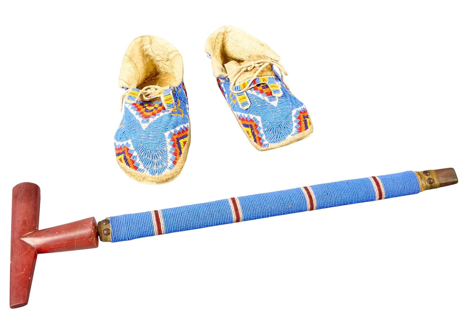 Red McCombs | Pair of Moccasins and Peace Pipe: Pair of Native American style moccasins decorated with intricate beadwork, and one peace pipe featuring matching blue beading, and ceramic bowl length 22 in. x height 7 in. x width 1.5 in. / pipe 