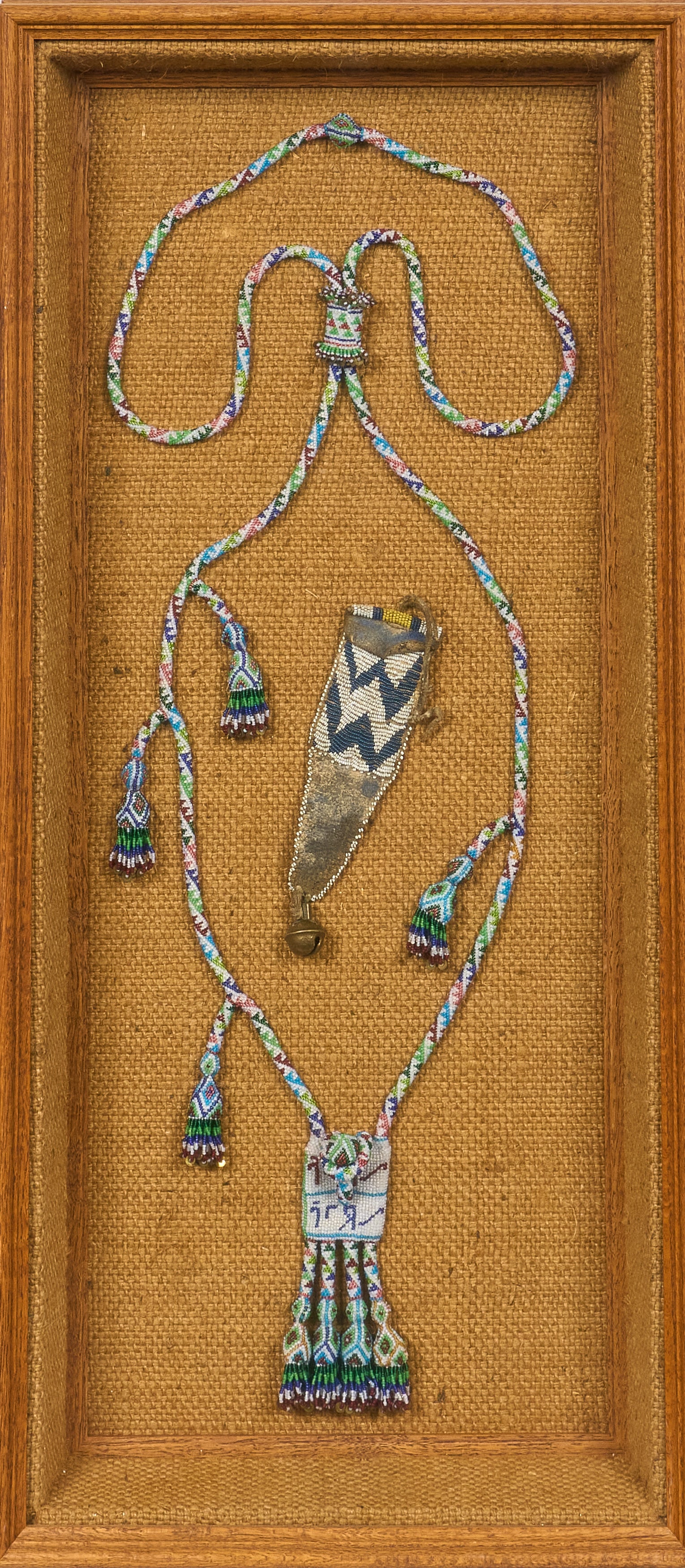 Red McCombs | Framed Native American Beaded Necklace and Pouch: Framed hand-beaded Native American pouch and long necklace height 33.5 in. x width 15.5 in. x depth 3 in. Provenance: Property from the personal estate collection of iconic Texas businessman, civic le