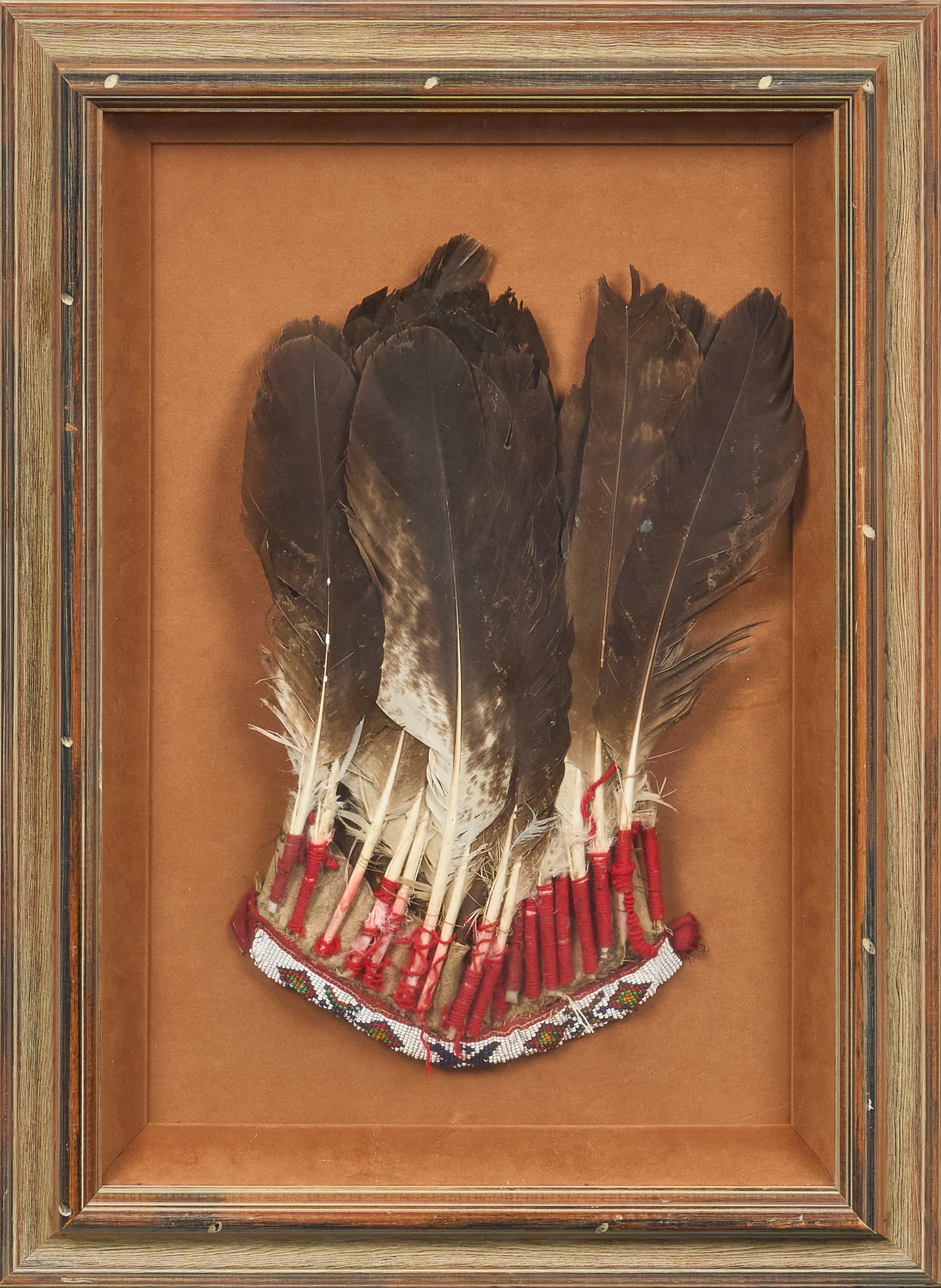 Red McCombs | Framed Native American Headdress: Framed Native American feathered headdress with hand-beaded decorative band height 27 in. x width 19.5 in. x depth 2 in. Provenance: Property from the personal estate collection of iconic Texas 