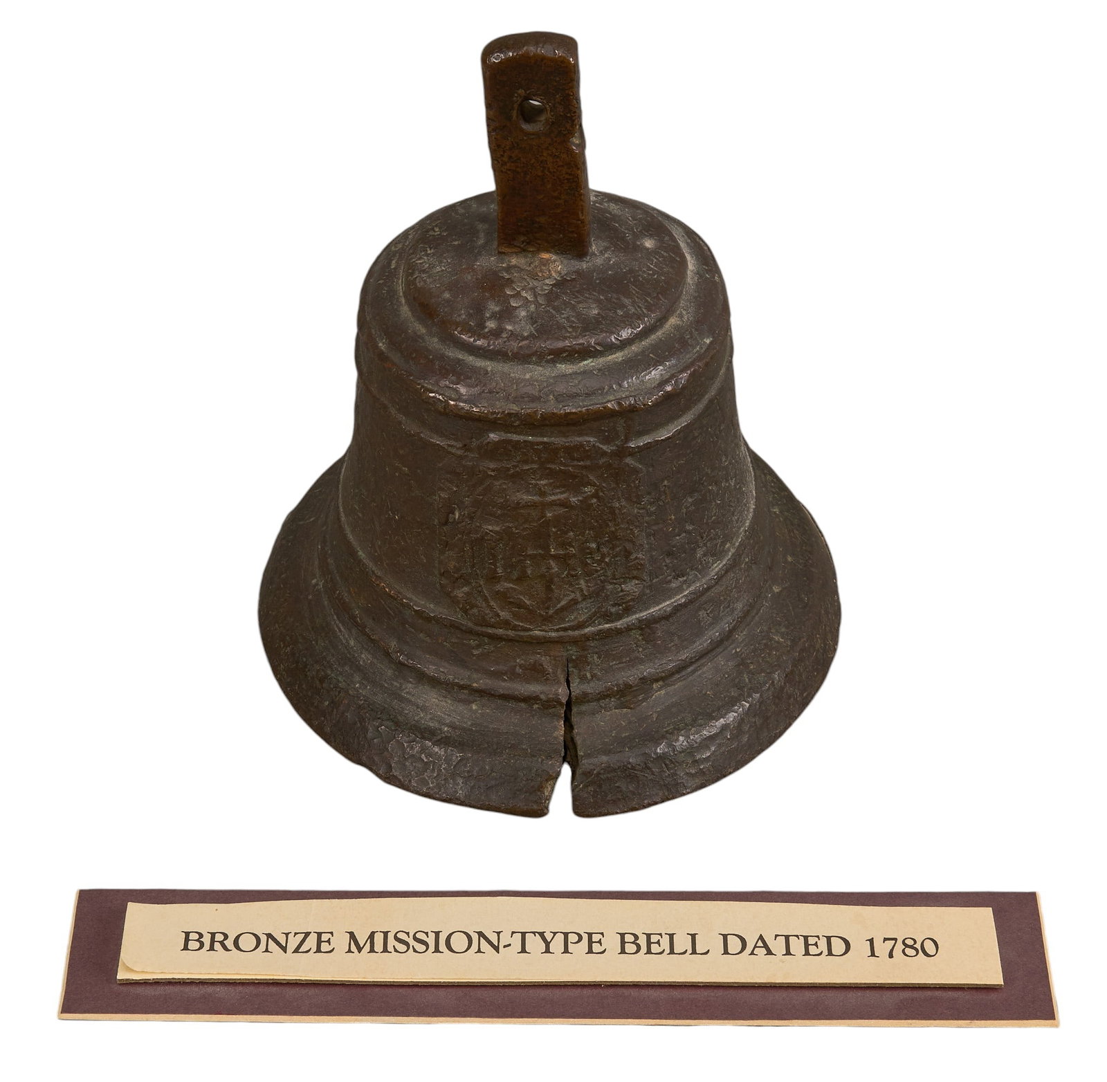 Red McCombs | Antique Bronze Mission Bell: Antique Mission bronze bell with crack, dated 1780, includes institution placard height 6.5 in. x width 5.5 in. x depth 5.5 in. 