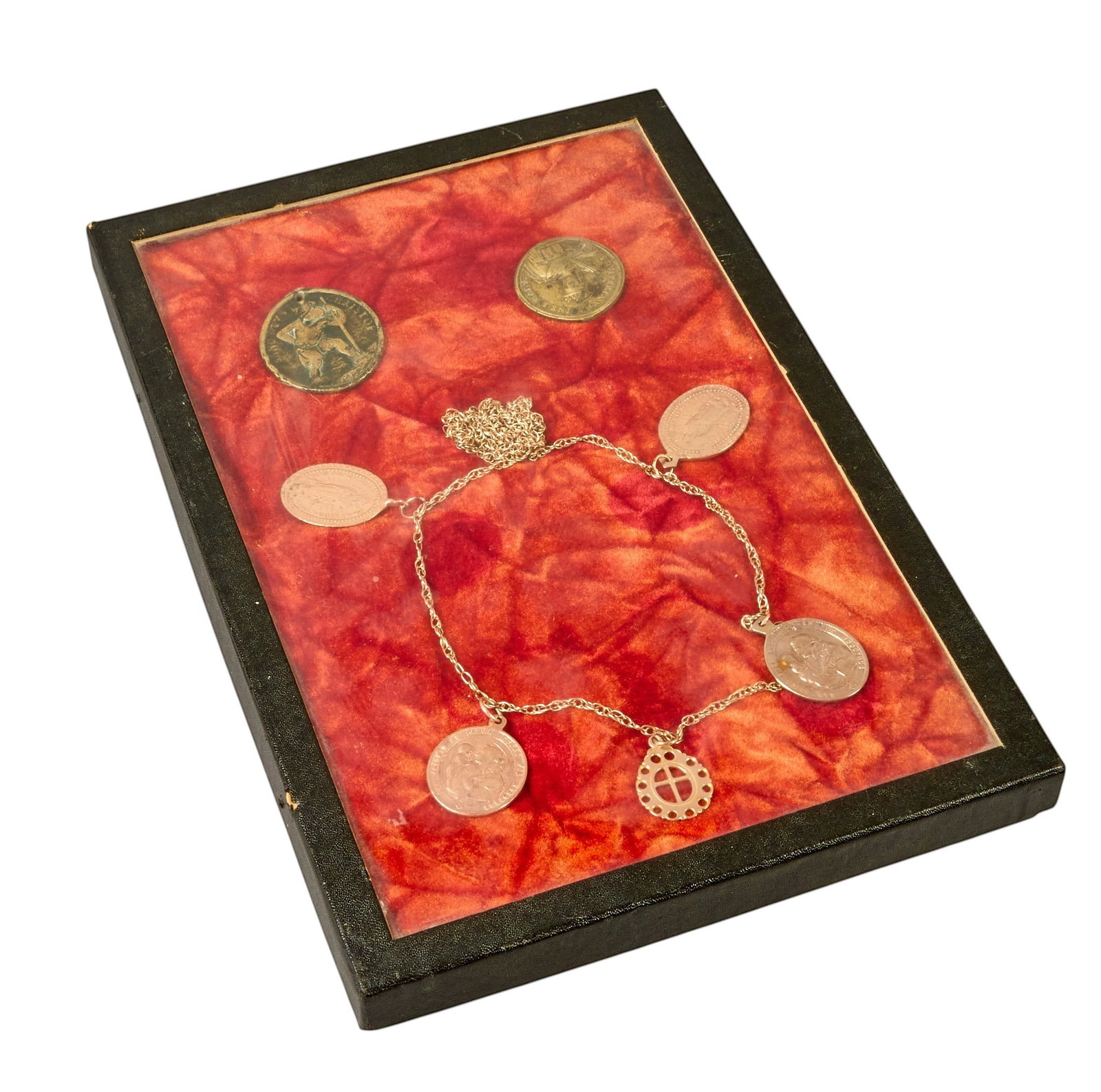 Red McCombs | Framed Collection of Religious Indulgences: Framed collection of antique religious devotional medals, pieces on chain ranging from 7K-10K gold, and two unattached medals composed of copper and zinc height 12 in. x width 8.5 in. x depth 1 in. / 