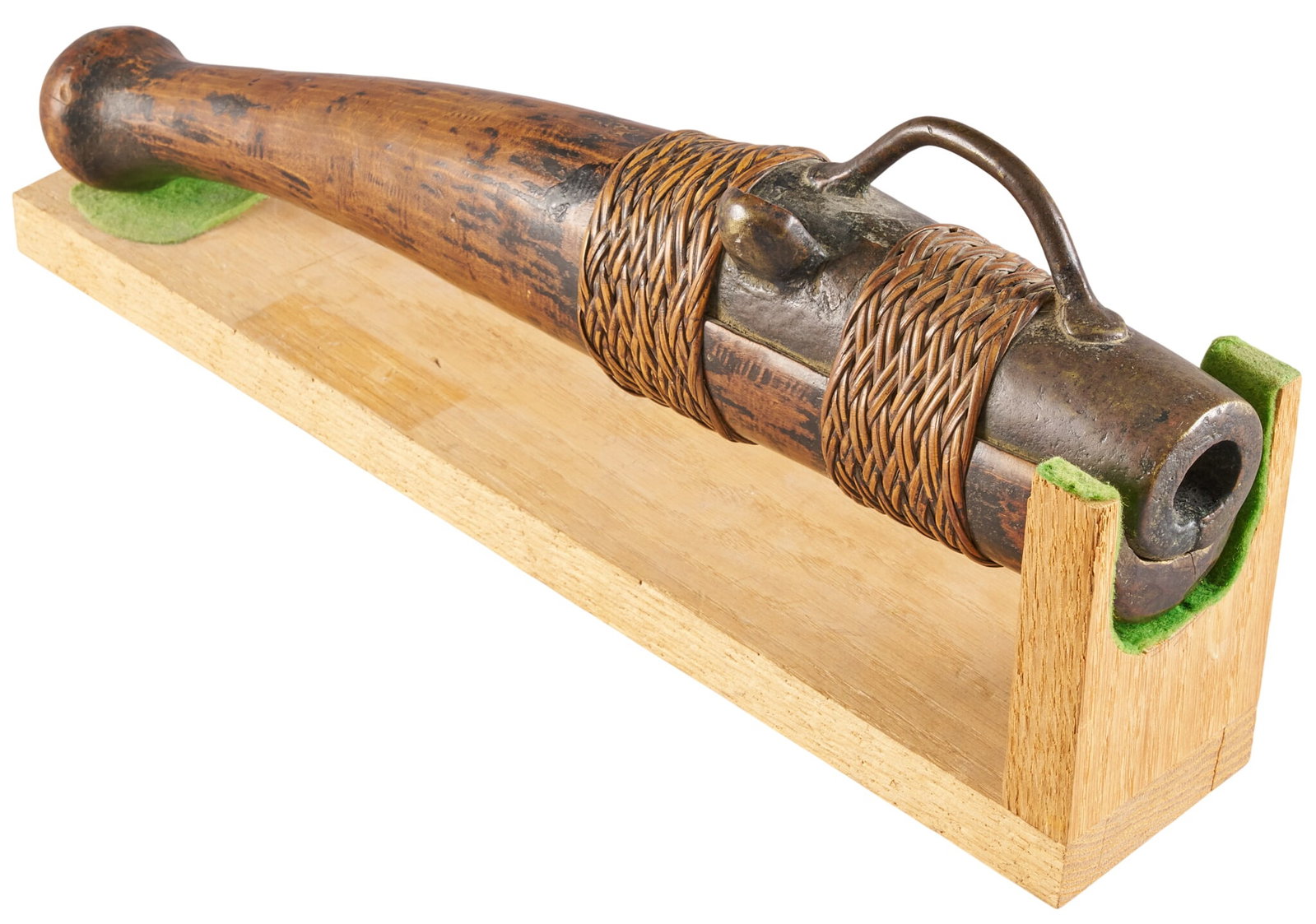 Red McCombs | Early Asian Hand Cannon Brought Back by Missionaries in The 1890's: 15th C. Asian hand cannon (huochong) on wooden stand, featuring brass barrel OAL: 16.5 in. condition commensurate with age Provenance: Property from the personal estate collection of iconic Texas busi