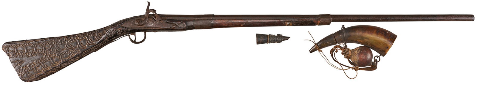 Red McCombs | Mid 19th Century African Tribal Carved Percussion Fusil W/ Accoutrements: Manufacturer: unknown (c. mid 19th c.) Model: Trade Musket Fusil Caliber: 58 cal. Barrel Length: 32 in. OAL: 48 in. Condition: Fair-antique; wood stock has significant wear w/ splititng & chipping