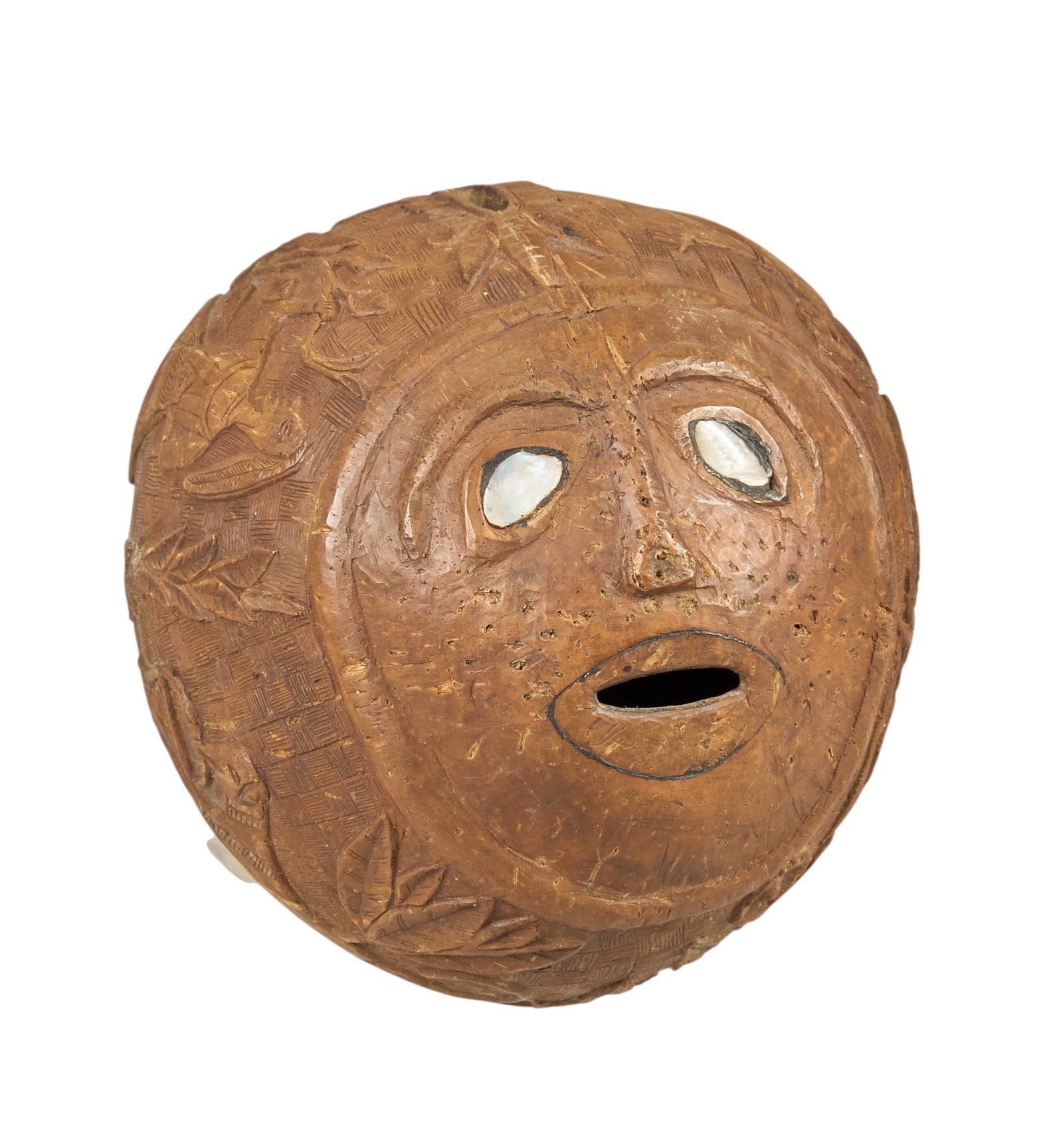 Red McCombs | Antique Whaler's Scrimshaw Coconut: Antique whaler's scrimshaw-carved coconut with face motif, and mother of pearl inlay decoration on eyes, circa mid-19th century, includes institution placard length 4.5 in. x width 5 in. 