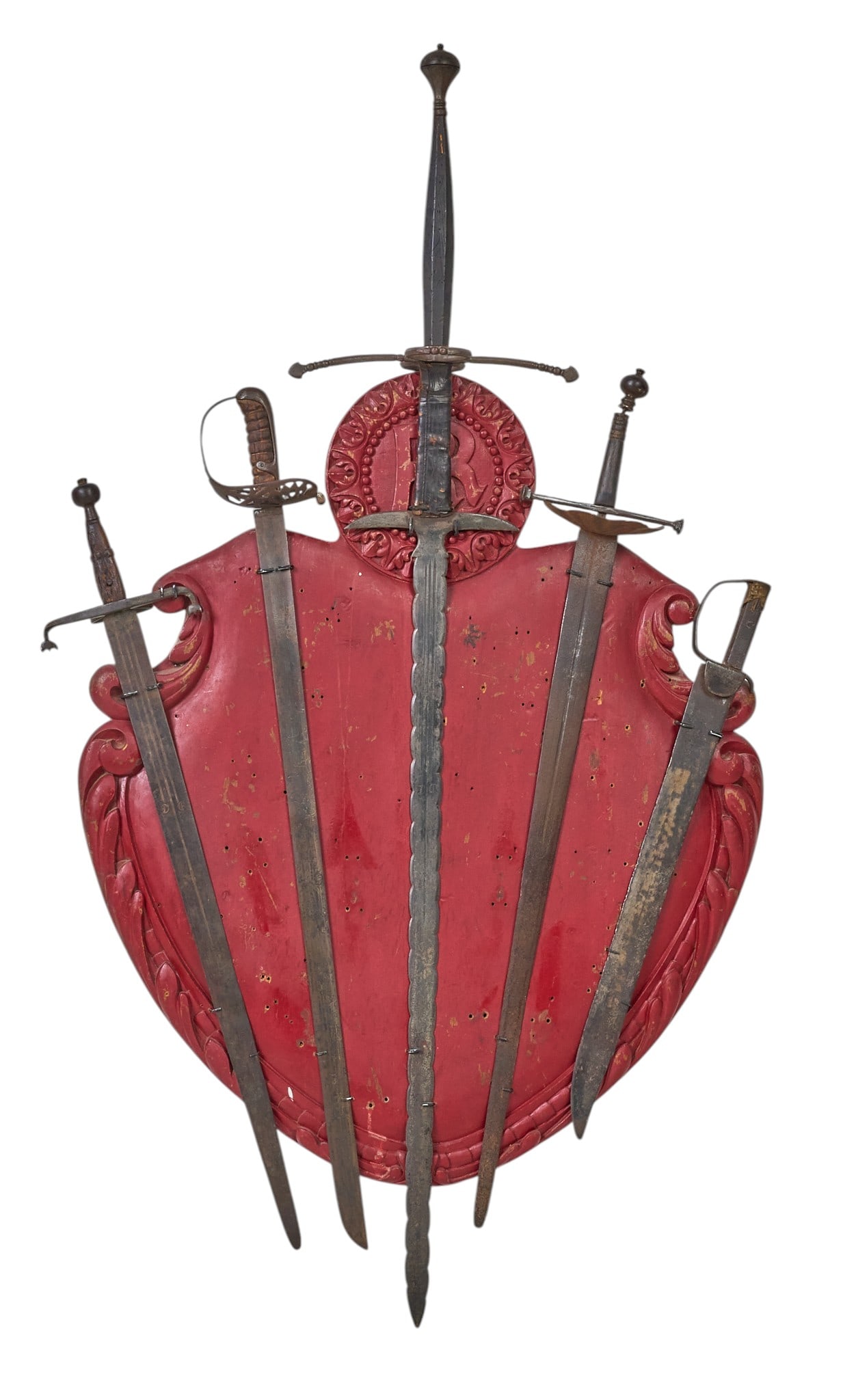 Red McCombs | 16th C. Toledo "Blades of Conquest" Panoply Display: Superb collection of five Toledo "Blades of Conquest" from the 16th century. These artifacts are mounted on a carved wooden base of Germanic origin. The base was used for target practice wit