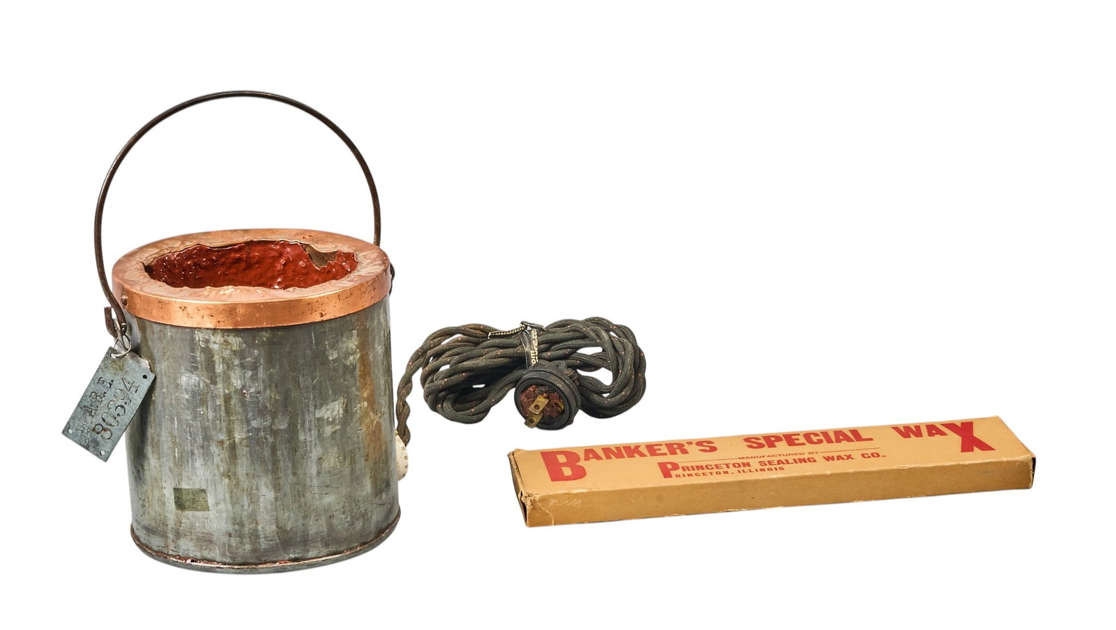 Red McCombs | Express Company Railroad Electric Stove and Melting Wax: Small electric stove to melt sealing wax, with extra bar of original express company wax, railroad marked, circa late 19th century height 9.5 in. x width 7 in. x depth 6 in. Provenance: Pro