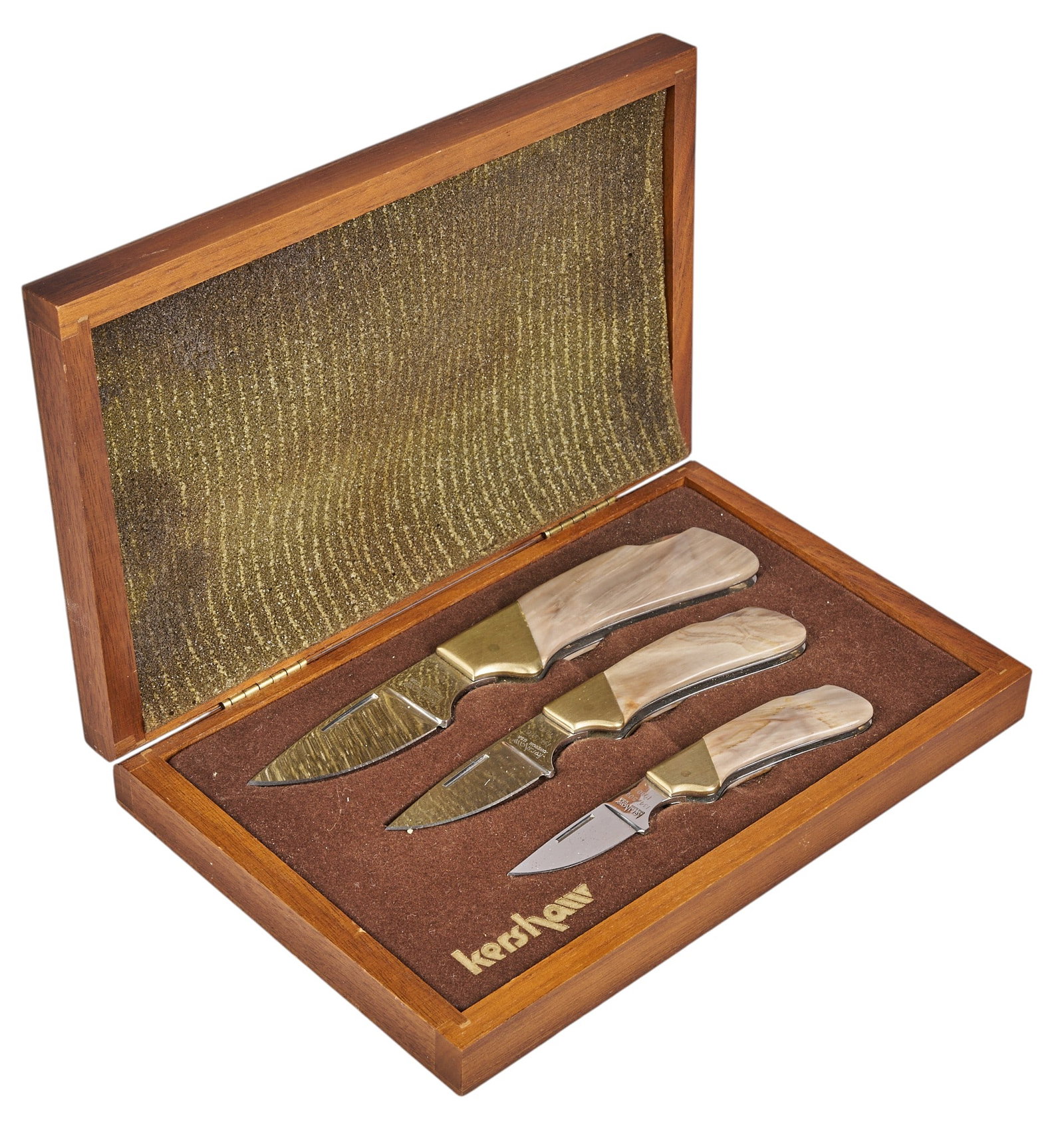 Red McCombs | (3) Piece Set of Kershaw Knives: Three piece set of Kershaw 1980 #134/500 knives presented in case; scales are made of petrified wood height 1.75 in. x width 8.5 in. x depth 5.5 in. Provenance: Property from the personal estate colle