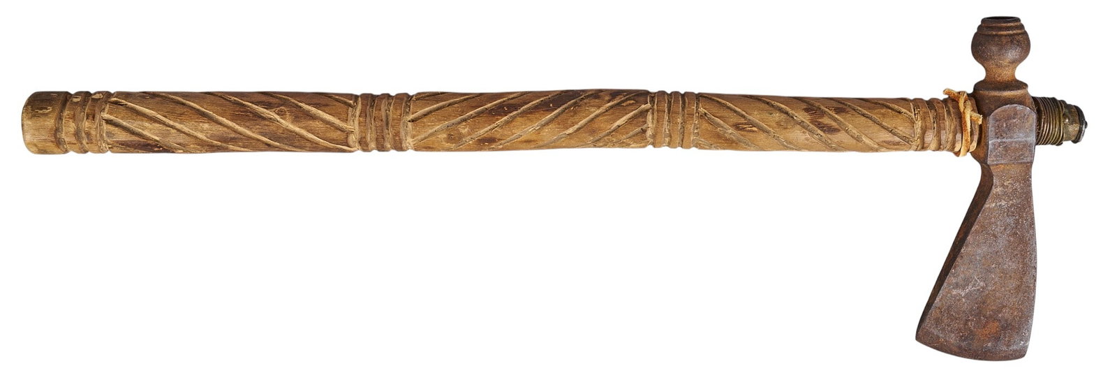 Red McCombs | Native American Carved Peace Pipe Tomahawk: Native American peace pipe tomahawk with rustic iron blade bowl and decoratively carved wooden shaft height 20 in. x width 7 in. x depth 1.5 in. Provenance: Property from the personal estate