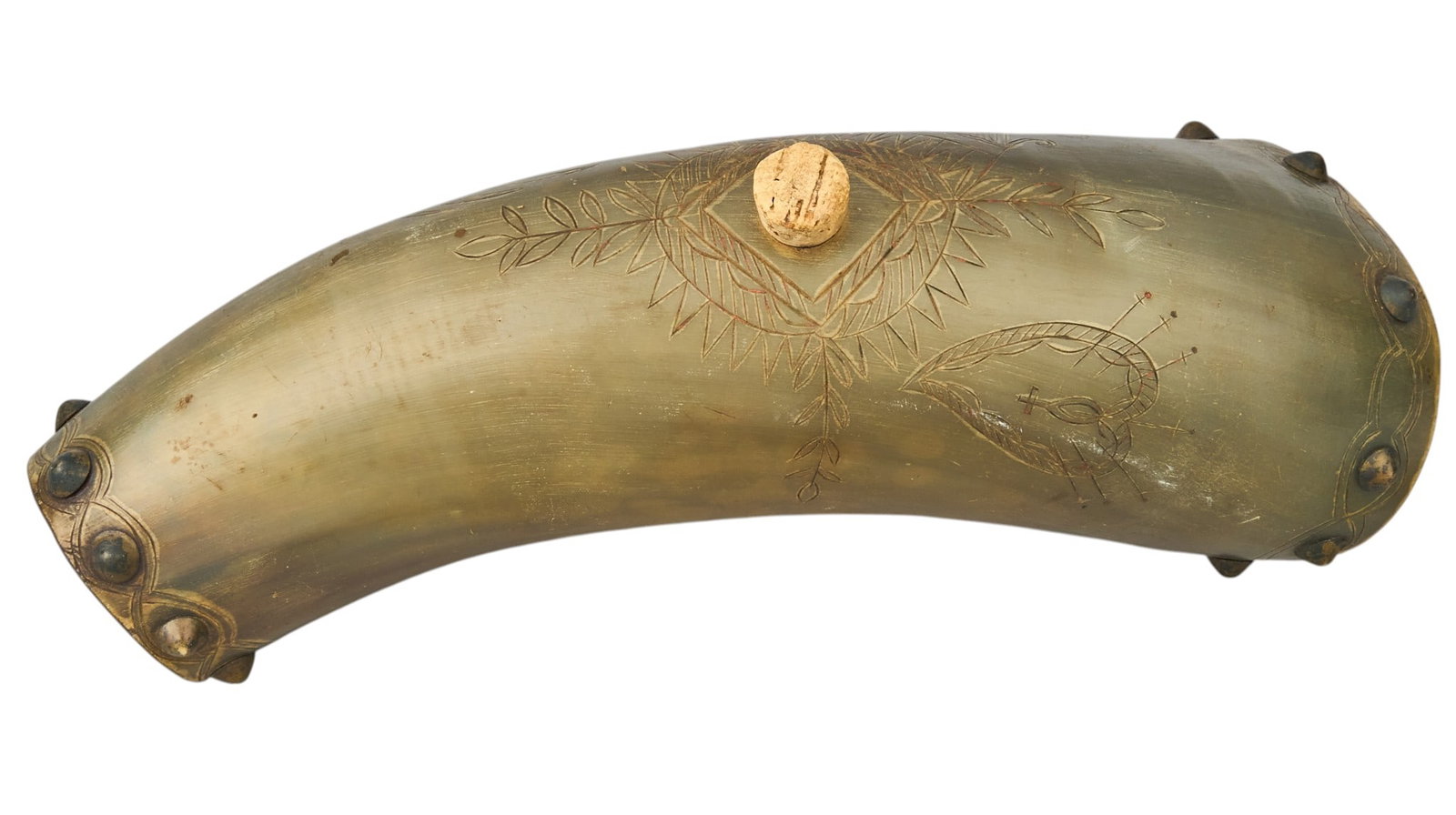 Red McCombs | Sacred Heart Scrimshaw Powder Horn: Sacred Heart scrimshaw decorated powder horn with cork length 9.5 in. x width 4.25 in. x depth 3.5 in. Provenance: Property from the personal estate collection of iconic Texas businessman, civic leade