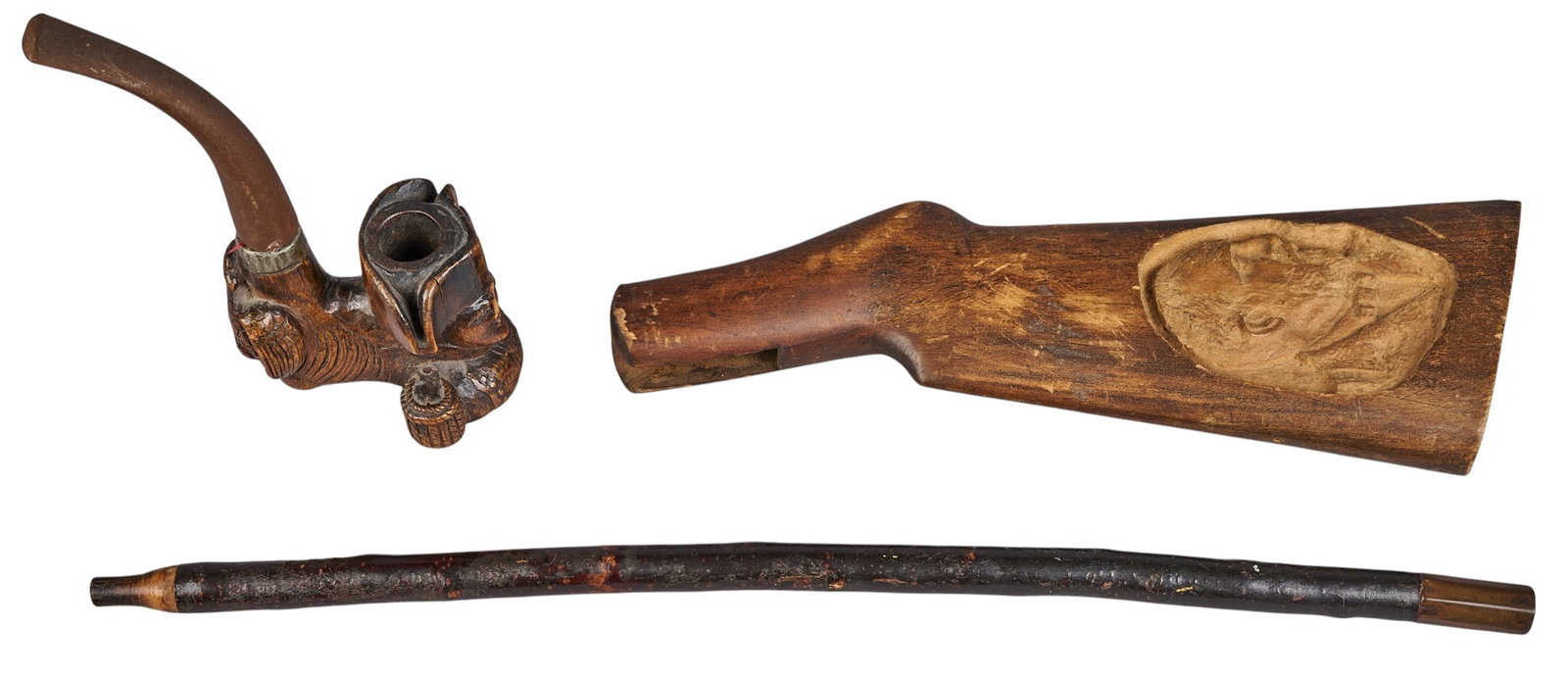 Red McCombs | (3) Antique Carvings: Three pieces of vintage carvings, includes a carved pipe in the shape of Napoleon Bonaparte, second quarter of the 19th century, with metal stem with a carved wood bowl, one wooden shotgun butt stock 