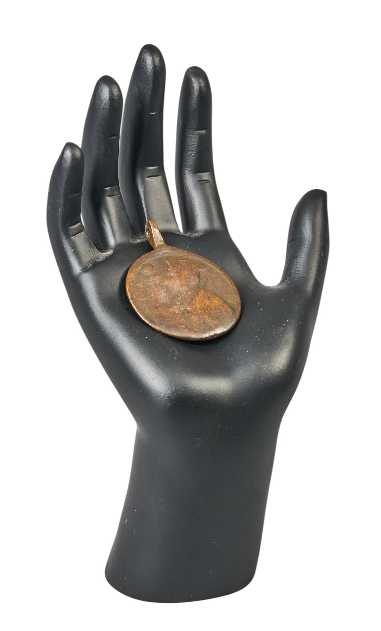 Red McCombs | Antique Copper Religious Pendant: Antique, worn copper medallion with bail, depicting saint on one side, and sacred heart on other, presented on modern hand display height 1.75 in. x width 1.25 in. Provenance: Property from
