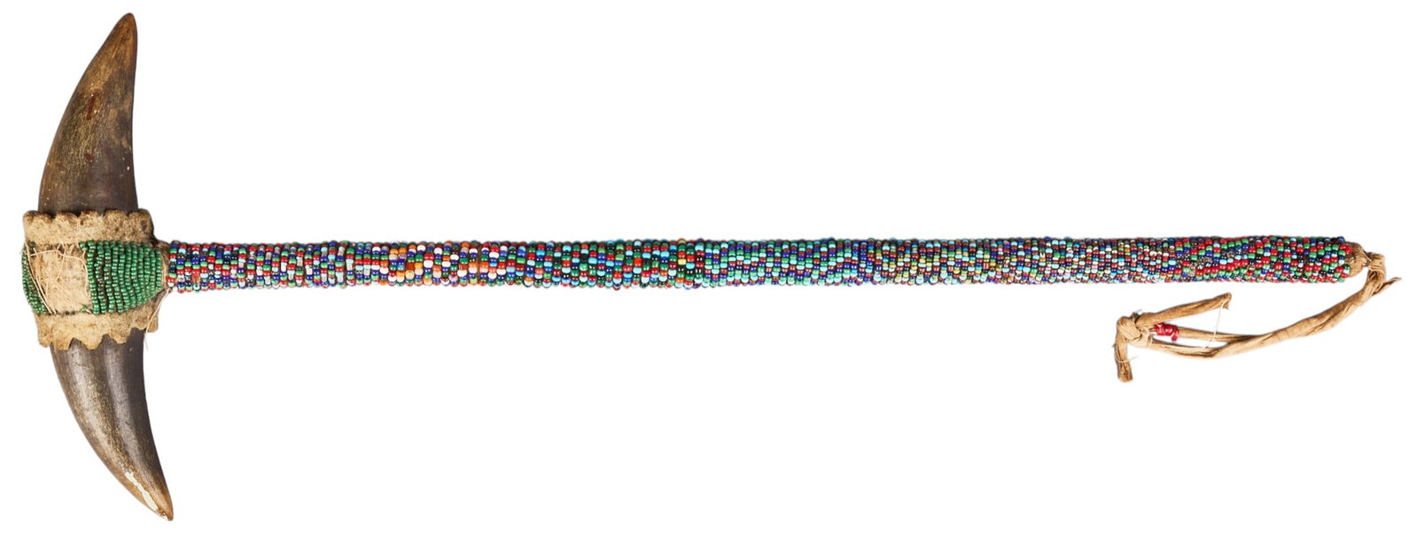 Red McCombs | Late 1800s Native American Buffalo Horn Club: Native American Buffalo horn plains ceremonial dance club with full beading, circa late 1800s, length 17 in. x width 7 in. x depth 2 in. Provenance: Property from the personal estate colle