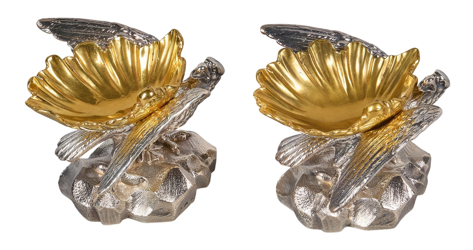 Red McCombs | Victorian Elkington Silverplate Eagle Master Salts: Pair of Victorian silverplate master salts by Elkington & Co., 1851, each featuring an eagle perched on a rocky base, holding a gilt-lined shell-form dish, hallmarked height 3 in. x width 5 in. x