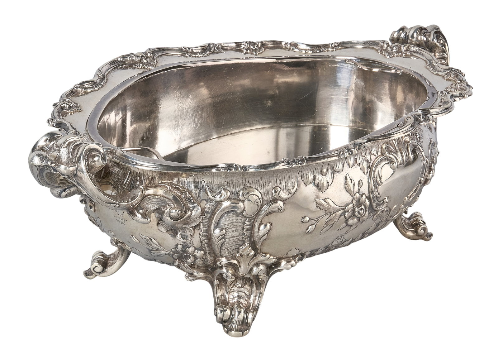 Red McCombs | Victorian Continental Silver Center Bowl: Victorian .800 fine silver center bowl by Gebrüder Friedländer, Berlin, 1880, with internal silverplate liner, repoussé design to exterior and handles, raised on scrolled feet height 
