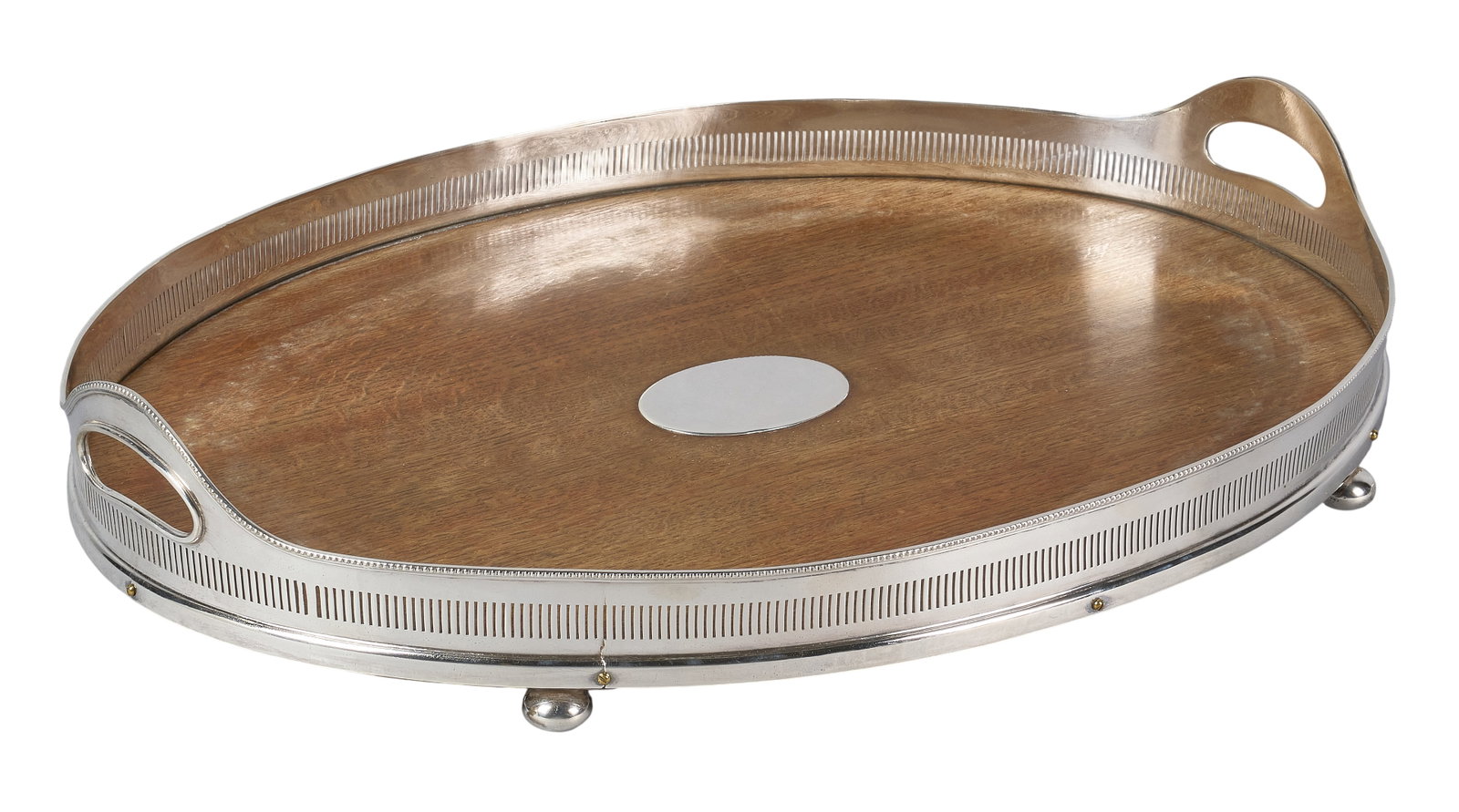 Red McCombs | Antique Silverplate Gallery & Wood Service Tray: Antique silverplate and wood oval service tray by Mappin & Webb, Sheffield, with gallery border and solid handles, raised on bun feet height 4 in. x width 24 in. x depth 18 in.