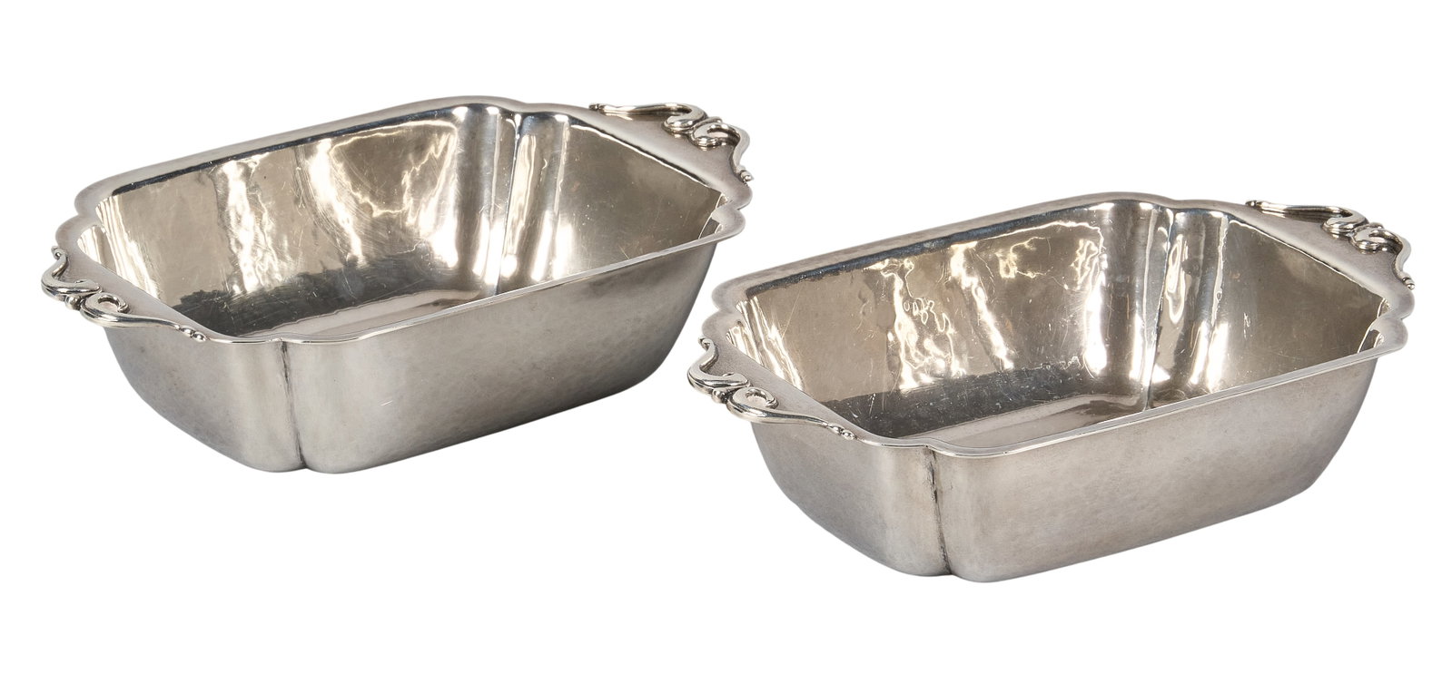 Red McCombs | Pair of Arts & Crafts Sterling Silver Cellini Table Bowls: Pair of Arts & Crafts sterling silver bowls by Cellini Craft, Chicago, hand-wrought and planished with applied scrolled handles, hallmarked height 2 in. x width 9 in. x depth 5 in. / each Total we