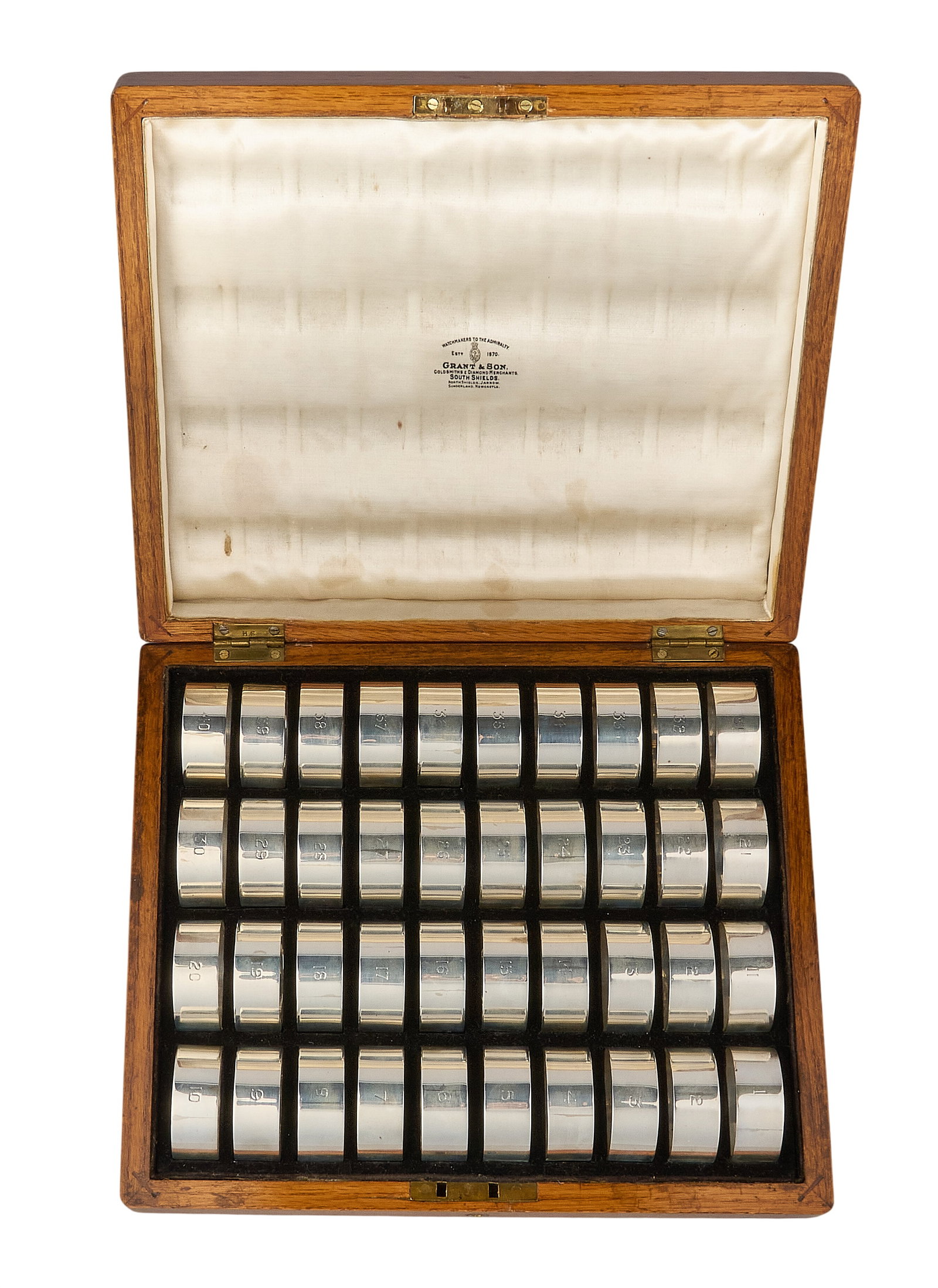 Red McCombs | Grant & Son Royal Artillery Regimental Silver Napkin Rings: Set of forty George V silver military napkin rings numbered 1 through 40, by Grant & Son, Birmingham, 1914, inscribed for the 87th Anti-Aircraft Regiment Royal Artillery, hallm