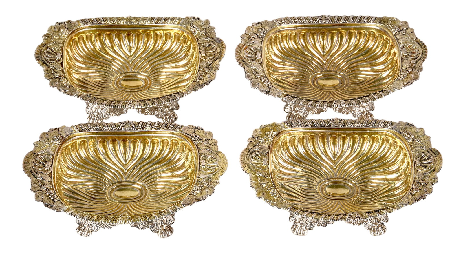 Red McCombs | (4) Georgian Sterling Silver Master Salts: Set of four Georgian sterling silver salt cellars by William Bateman I, London, 1818-19, with parcel gilt finish, featuring repoussé design throughout, raised on paw feet height 2 in. x wi