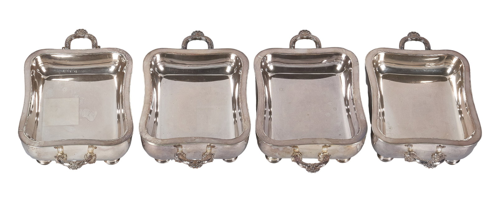 Red McCombs | (4) Victorian Silverplate Warming Dishes: Four Victorian silverplate warming dishes, rolled plate, with tin linings, raised on wooden bun feet, circa 1850 height 4 in. x width 15.5 in. x depth 9 in. / each Total weight: 9.