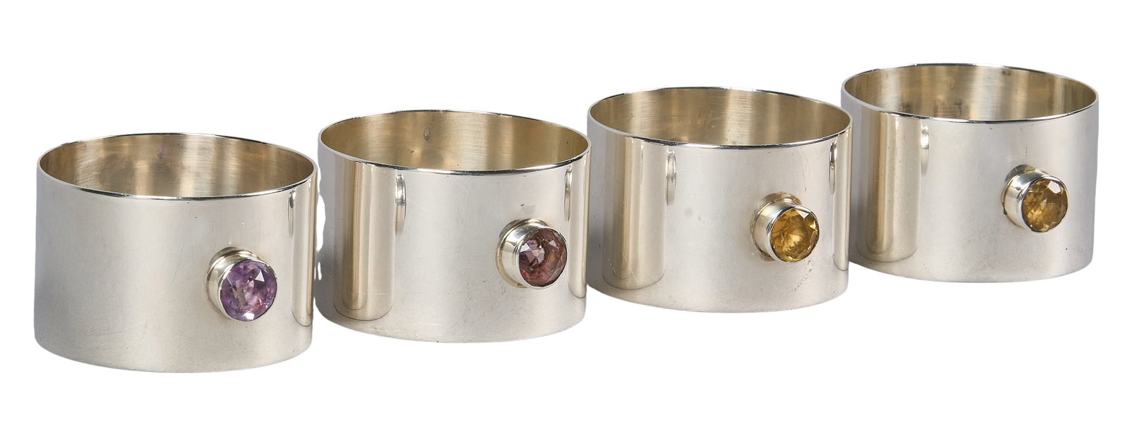 Red McCombs | (4) Sterling Silver Agate Napkin Rings: Set of four sterling silver napkin rings by William Dunningham Co., Edinburgh, 1946, each set with a bezeled round agate detail to exterior, hallmarked height 1.25 in. x diameter 1.75 in. / 