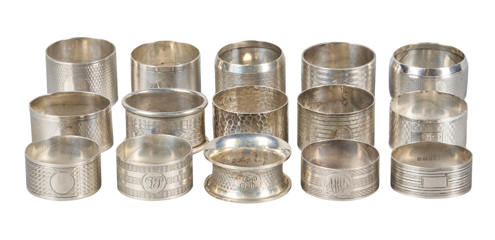 Red McCombs | (15) Antique English Sterling Silver Napkin Rings: Collection of fifteen antique sterling silver napkin rings, several with monograms and hallmarks height 1.5 in. x diameter 2 in. / largest Total weight: 12.4 ozt Provenance: Property from the