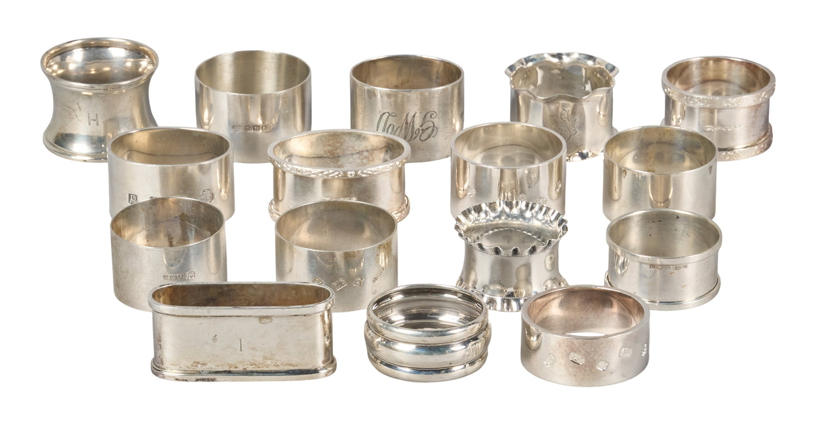 Red McCombs | (16) Antique English Sterling Silver Napkin Rings: Collection of sixteen antique English sterling silver napkin rings, several with monograms and hallmarks height 1.5 in. x diameter 2 in. / largest Total weight: 18.8 ozt Provenance: Property from the
