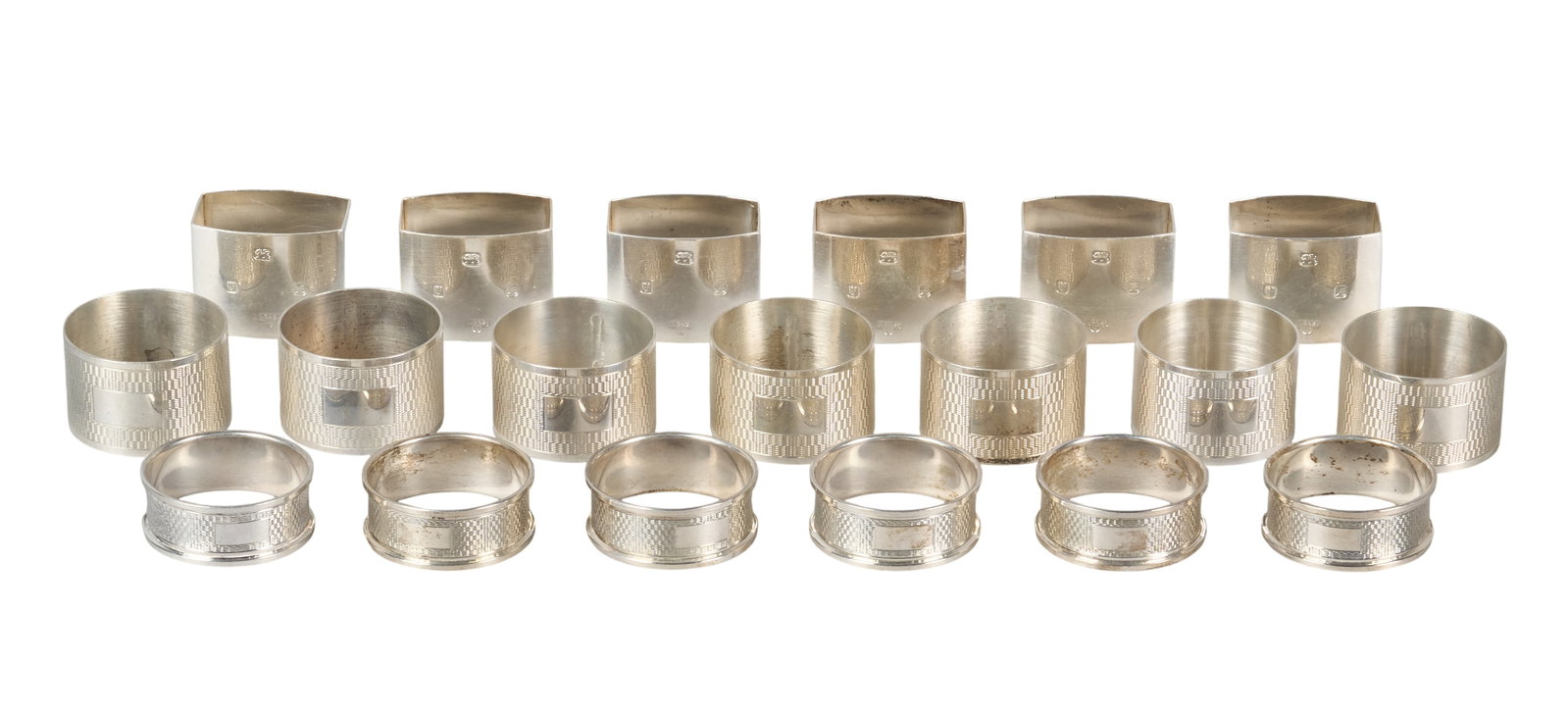 Red McCombs | (19) Antique English Sterling Silver Napkin Rings: Collection of nineteen antique sterling silver napkin rings, featuring three matching sets, stamped with hallmarks height 1.5 in. x diameter 2 in. / largest Total weight: 15.3 ozt Provenance: Pro