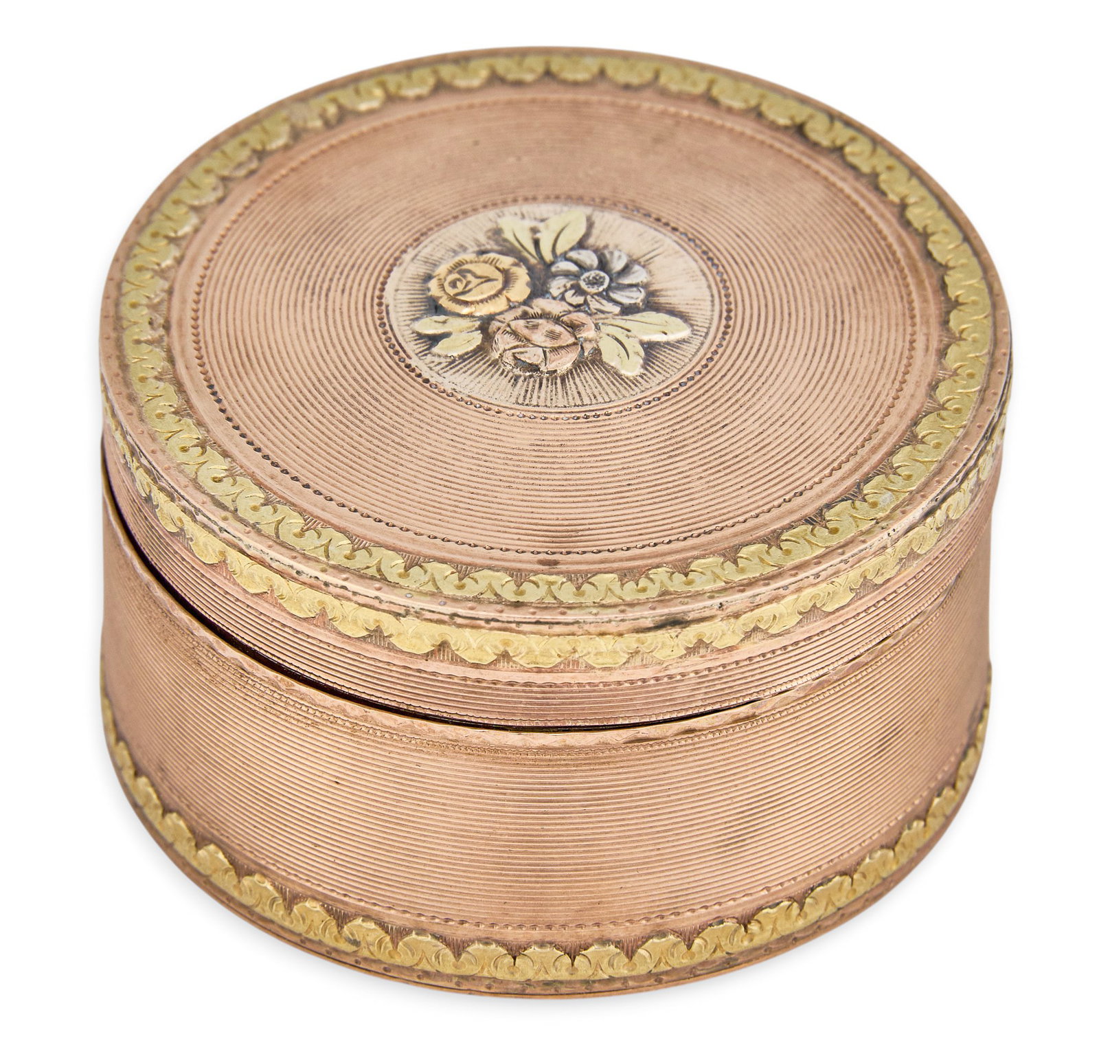Red McCombs | Antique 14K Two-Tone Vanity Box: Antique vanity box crafted from 14K bi-color gold, featuring a gold foliate border and line engraving, with central floral medallion to lid, hallmarked height 1 1/8 in. x diameter 2 in. Total weight: 