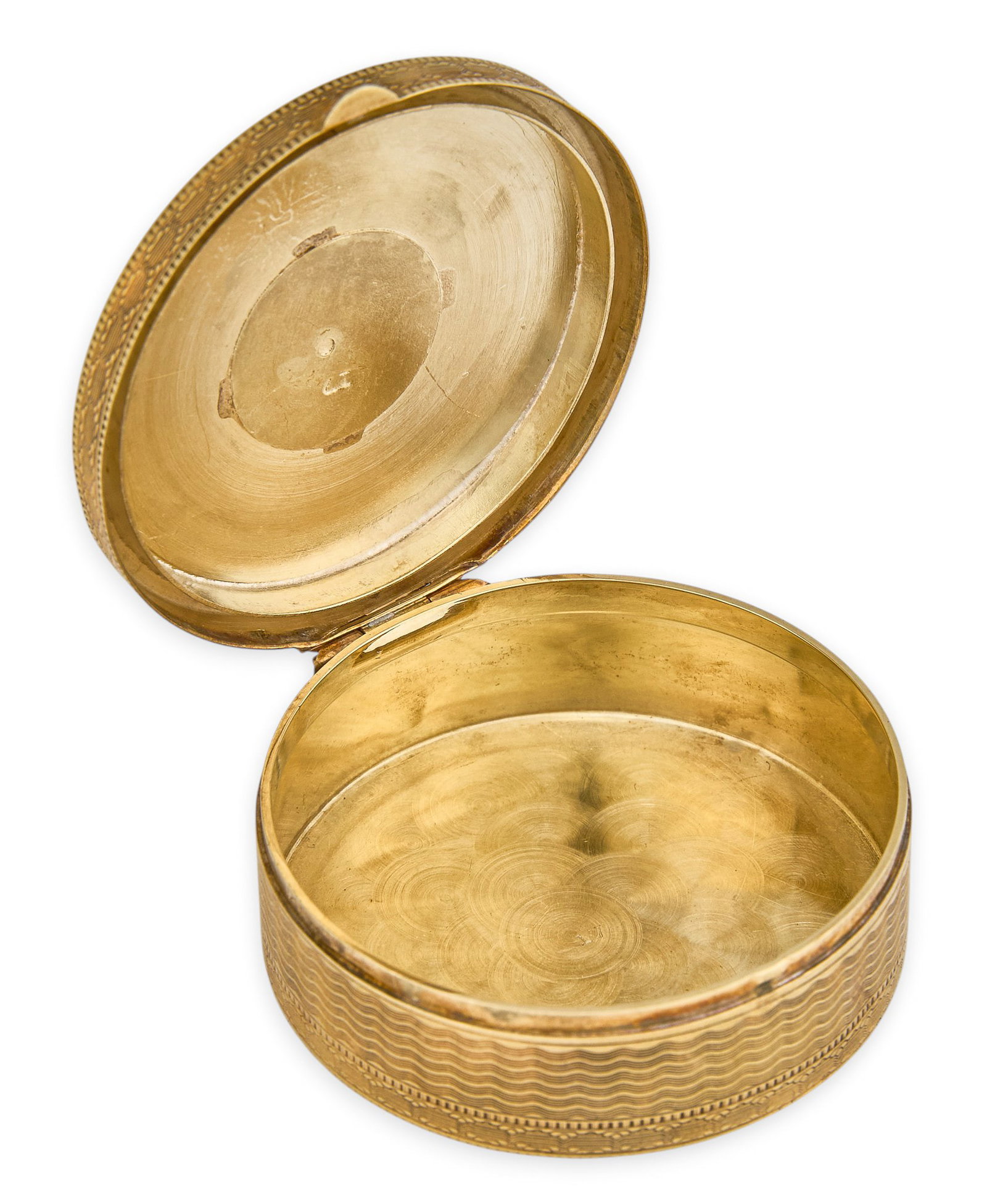 Red McCombs | 14K Art Deco Chatelaine Box: 14K gold Art Deco chatelaine box, featuring intricate radiating sunburst line engraving, engine turning, marked "17" Size: 1 3/8 in. / diameter Total weight: 20.3 g Provenance