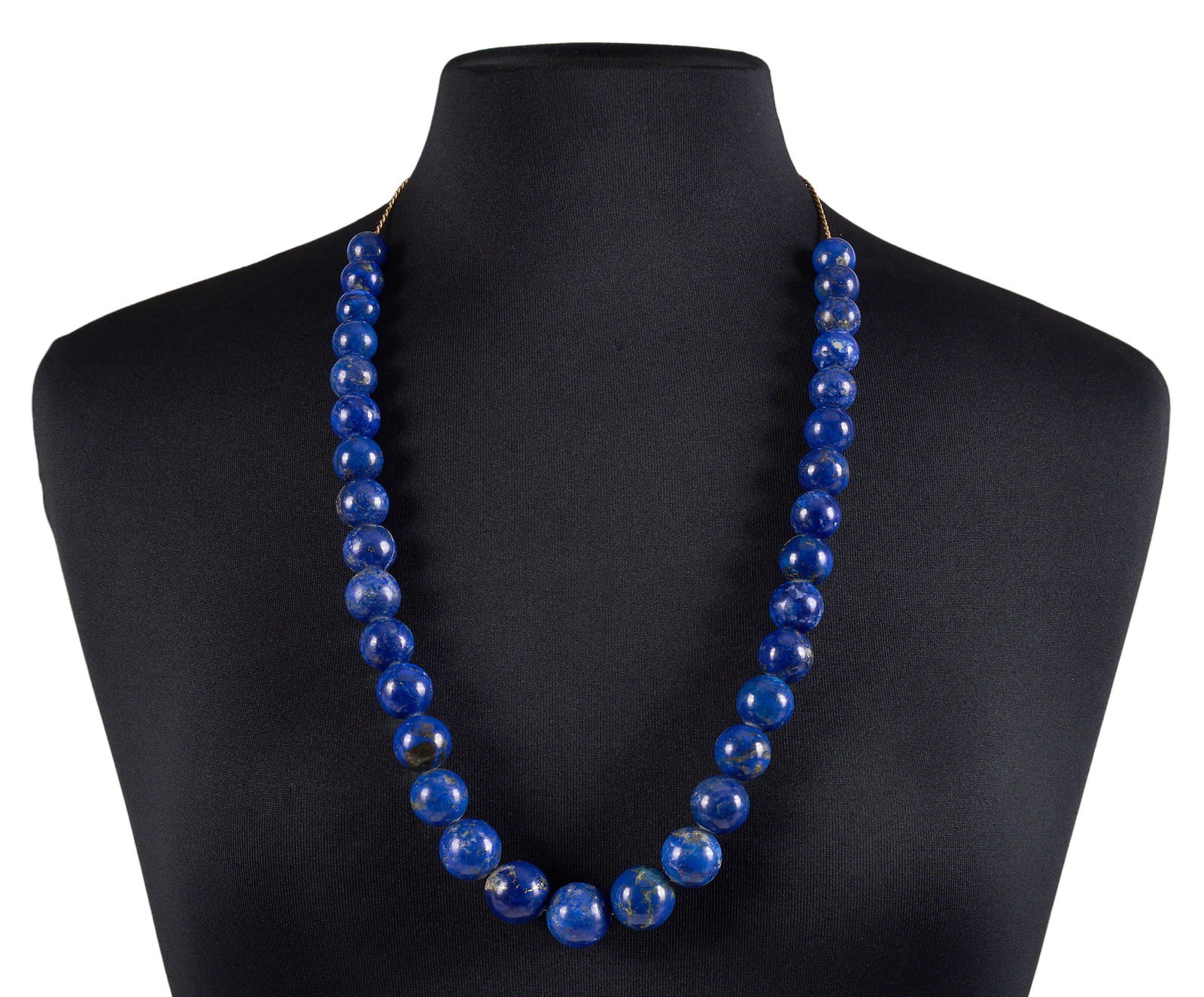 Red McCombs | 14K Beaded Lapis Necklace: 14K yellow gold necklace with graduated round lapis beads, on twisted rope chain, clasp marked "14K" Length: 30 in. Total weight: 200.4 g Provenance: Property from the personal estate c